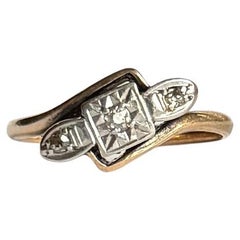Art Deco Diamond Platinum and 9 Carat Gold Twist Three Stone Ring