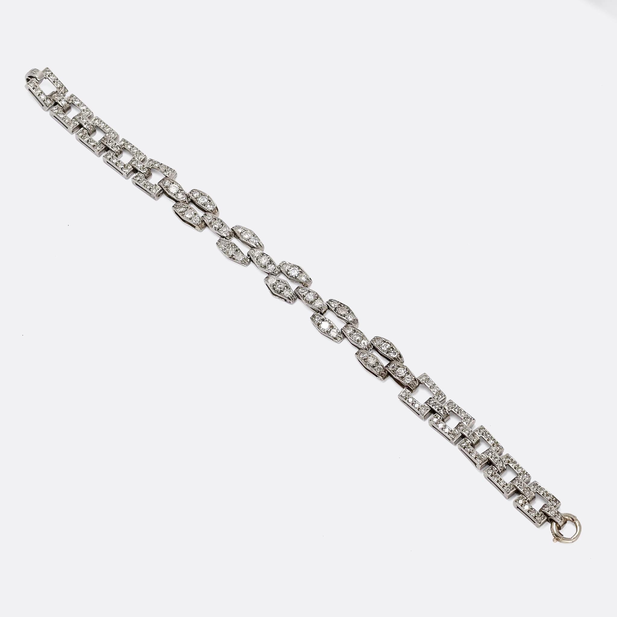 A gorgeous diamond bracelet dating from the Art Deco period, circa 1930. It's made up of two different styles of link: open squares around the claps, and rhombus chequerboard links in the middle. They're all diamond-set and crafted in platinum