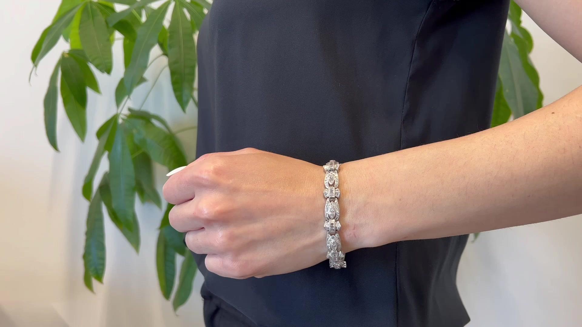 One Art Deco Diamond Platinum Bracelet. Featuring nine antique marquise cut diamonds with a total weight of approximately 1.60 carats, graded near-colorless, VS-SI clarity. Accented by 146 single cut and baguette cut diamonds with a total weight of