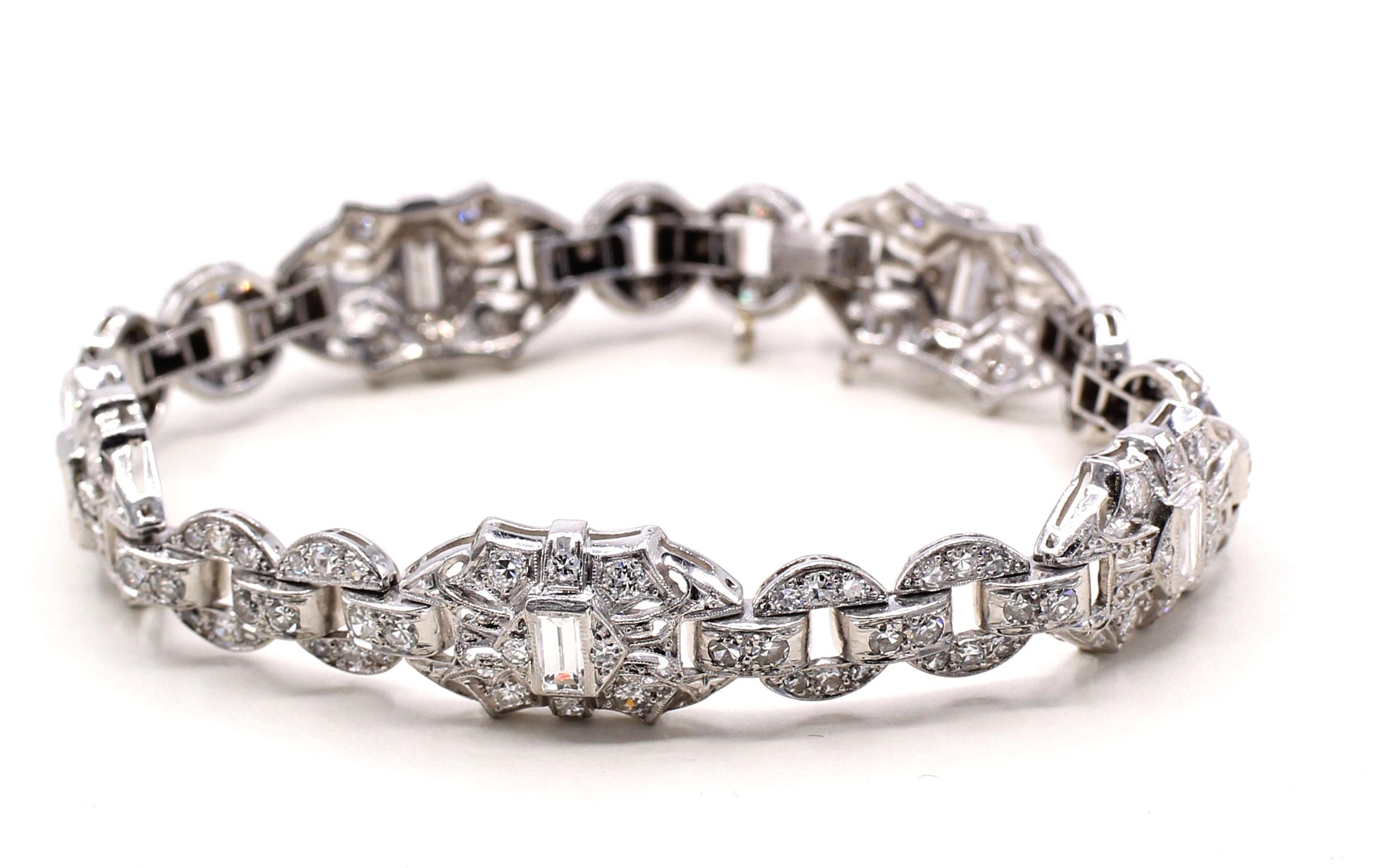 Art Deco bracelet from ca 1935 handcrafted in platinum and set with round old cut and baguette diamonds. Geometric design with flexible links, 6.65 inches long.