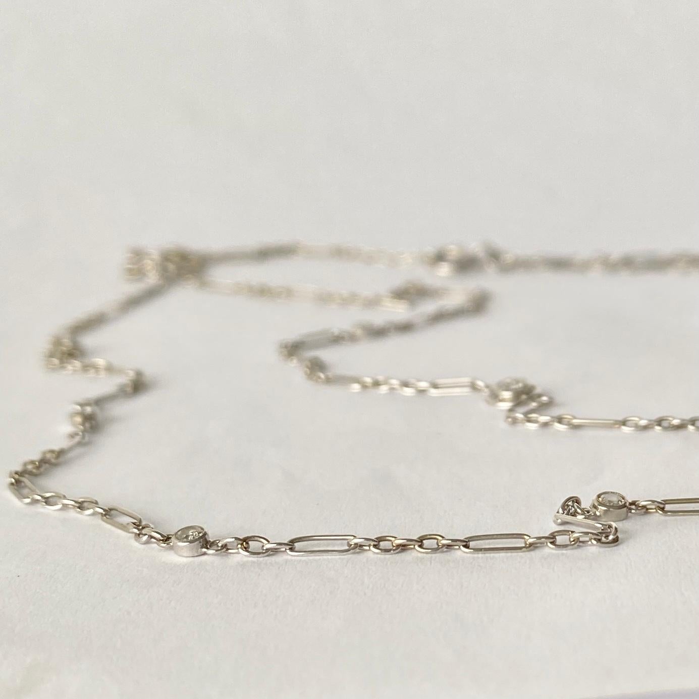 An elegant Art Deco chain necklace set with diamonds and modelled in platinum. Each diamond is sat in a delicate circle of platinum or is simply set alone. The diamonds totals 1carat and are bright and add the perfect sparkle to this chain! There