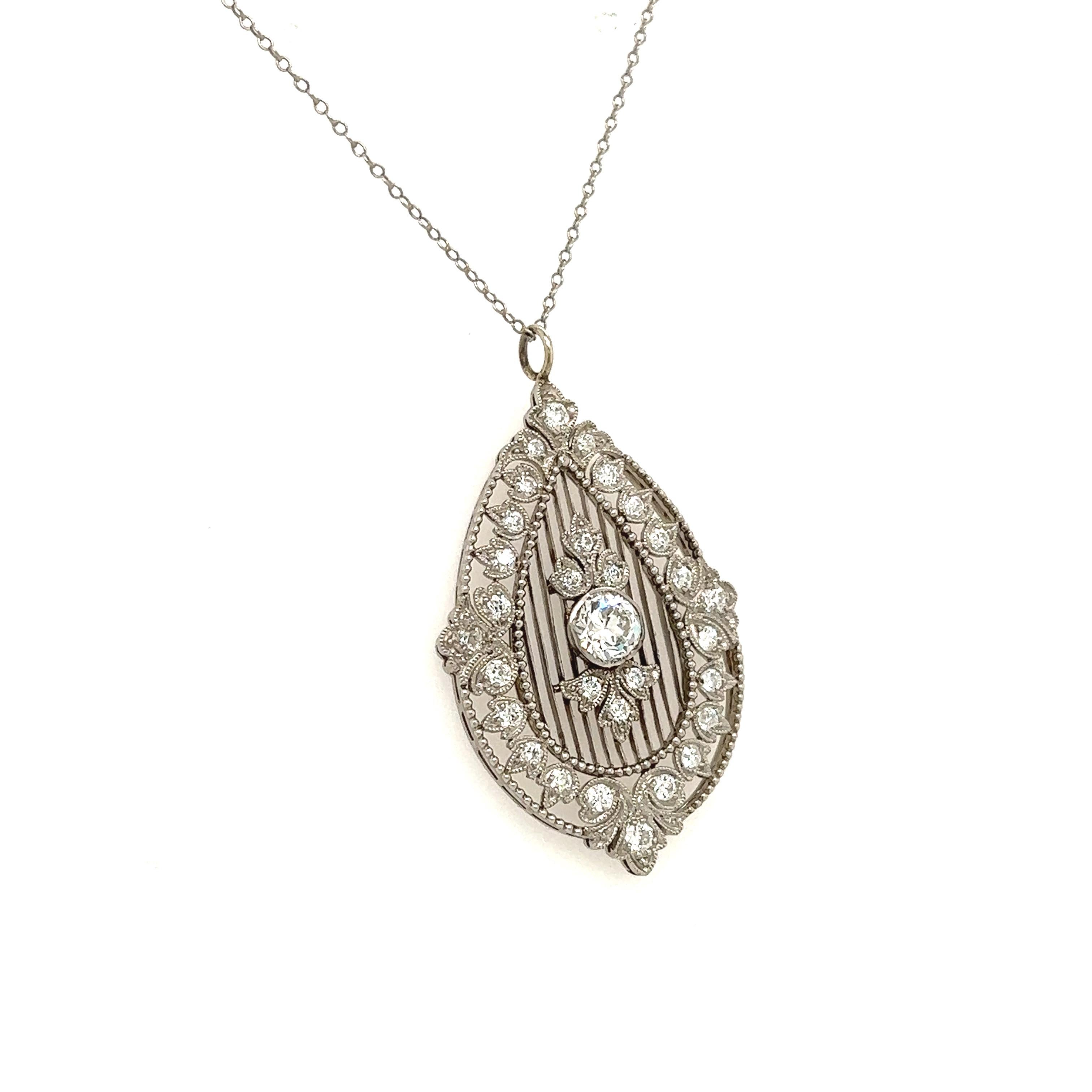 Gorgeous Art Deco creation crafted in platinum. The pendant is delicately crafted with details at every angle.  Filagree and sharp angles are seen throughout the necklace as only a true master of the craft could create. The highlight of the pendant
