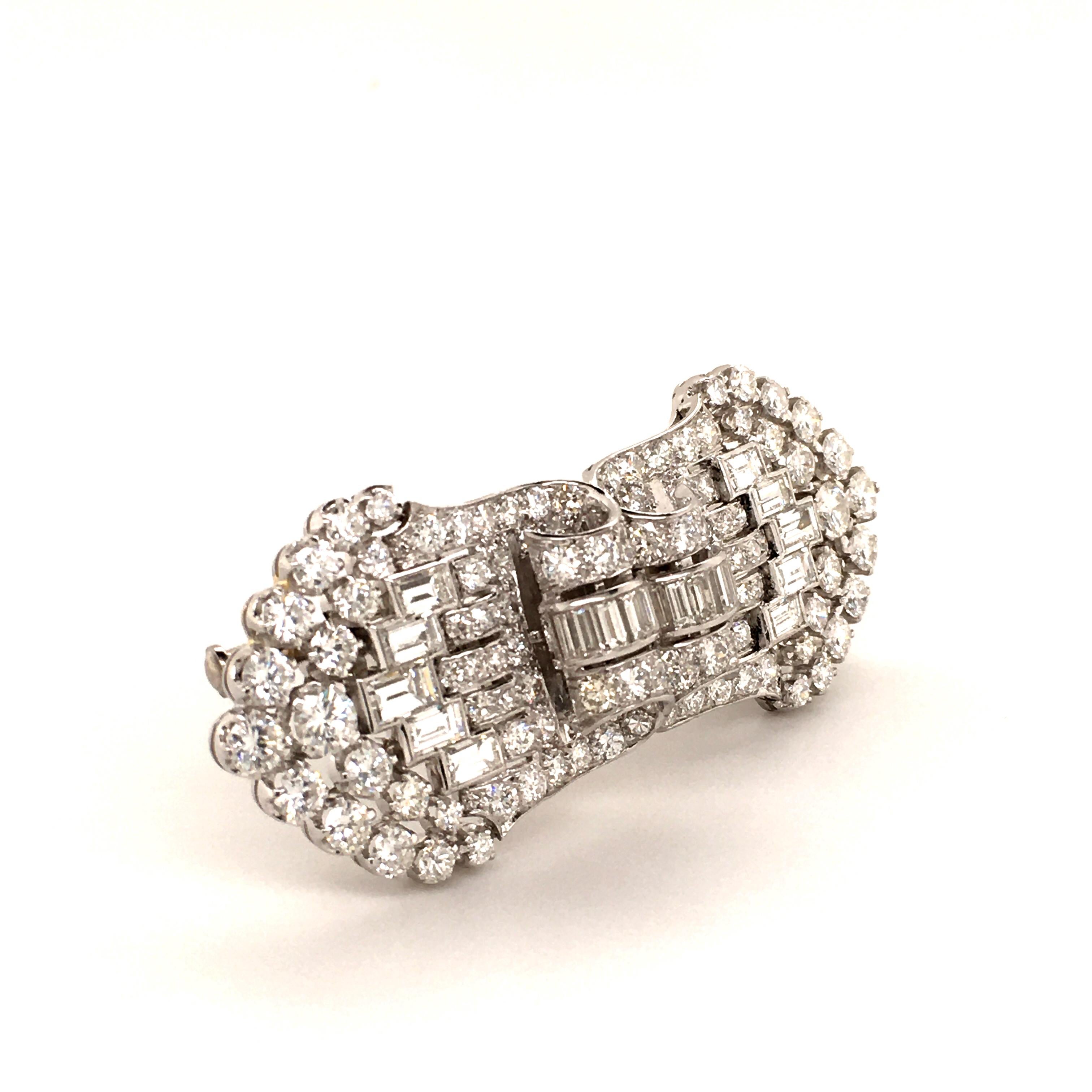 Art Deco diamond double clip brooch, set with approximately 7.10 carats of diamonds (22 baguette-cut and 112 old-cut and single-cut), G/H color and vs clarity. Mounted in platinum 950 with 18 karat white gold fitting.
Can be worn as one brooch or
