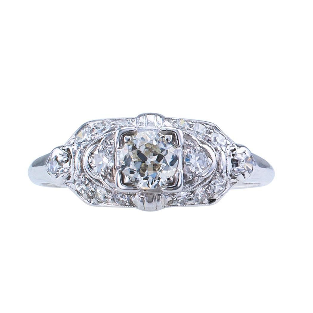 Art Deco diamond and platinum engagement ring circa 1930.

DETAILS:
Art Deco diamond and platinum engagement ring.
DIAMOND: approximately 0.33 carat, approximately H - I color and SI clarity.
DIAMONDS: sixteen smaller round diamonds totaling