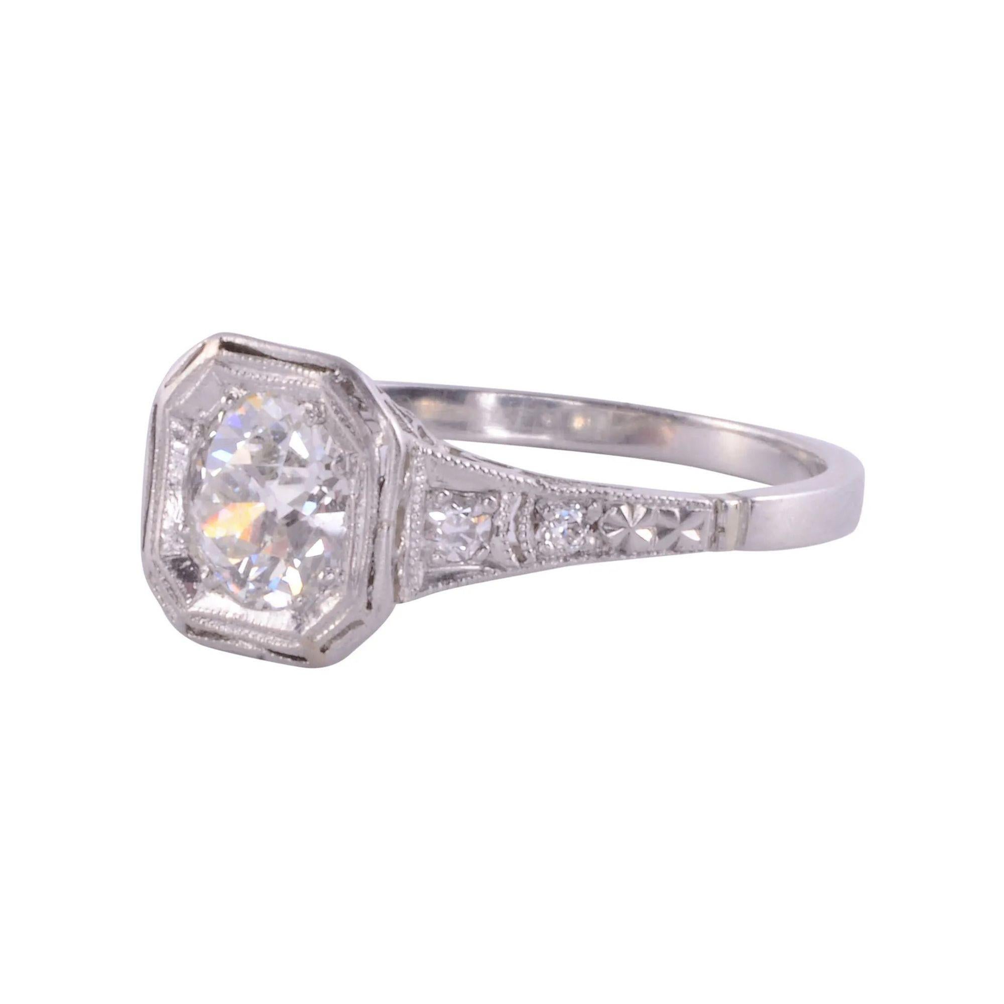 Antique Art Deco diamond platinum engagement ring, circa 1920. This platinum Art Deco engagement ring features a .67 carat old European cut center diamond. The diamond has VS2 clarity and K color. There are four old European cut accent diamonds at