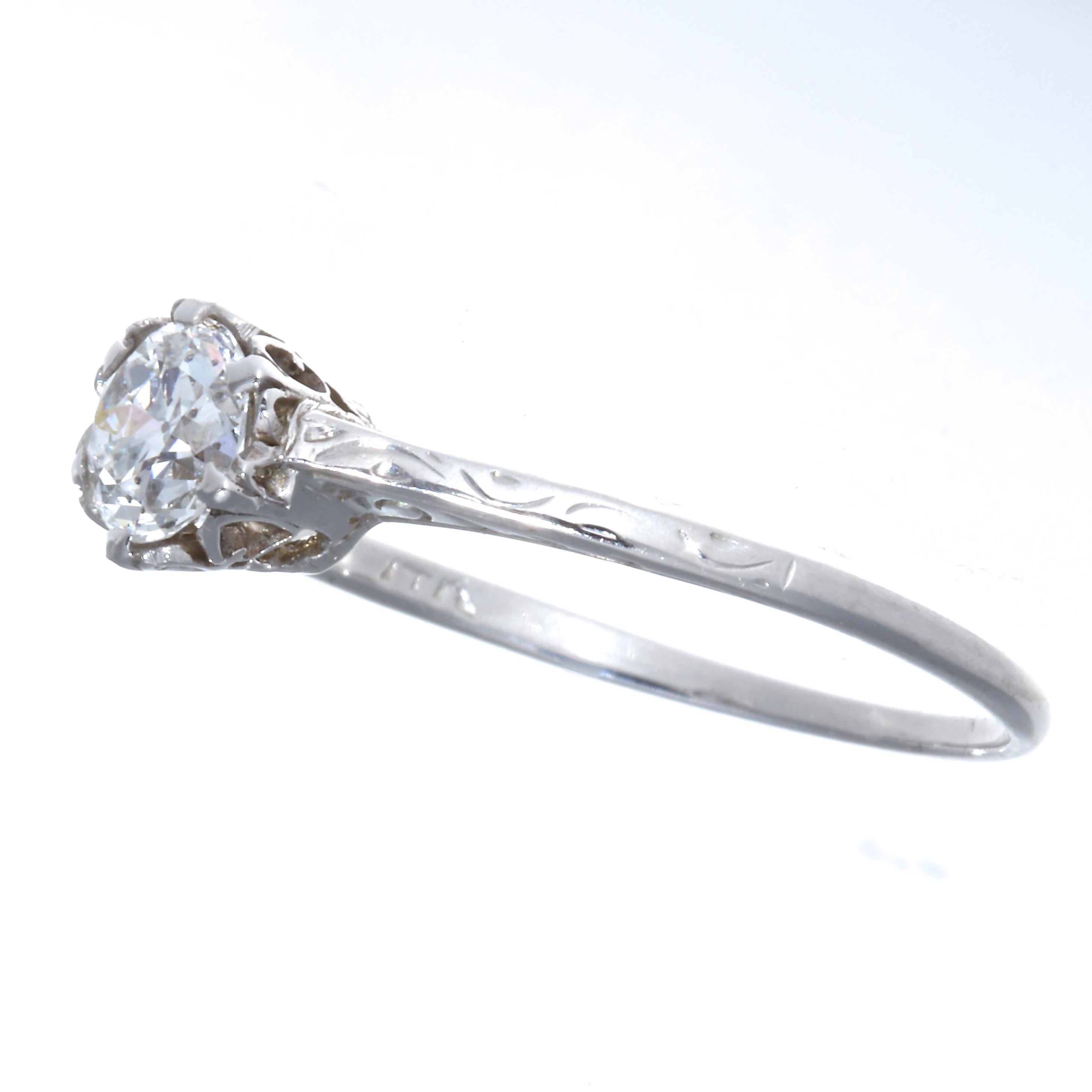 This sweet art deco creation  features a worthy diamond weighing approximately 0.50 carats graded as F,G color, VVS2 clarity. The finely filigreed ring is in platinum, size 8 1/2 and may be re-sized to fit. Circa 1920's. 
Flawless Protection Plan: