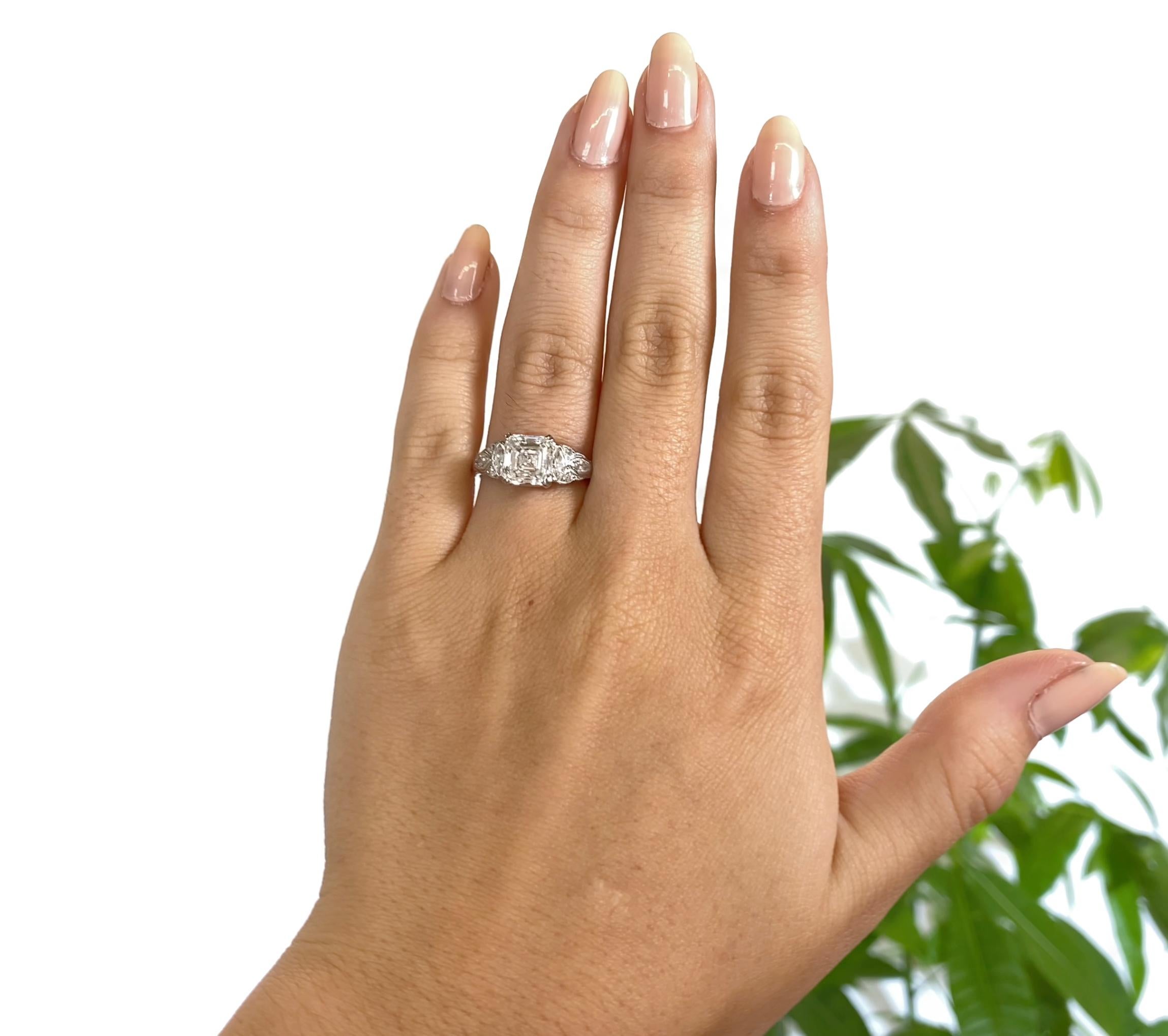 Art Deco Diamond Platinum Engagement Ring. The center diamond is a GIA certified emerald cut, 2.01 carat, H color, SI1 clarity (#1156059607). Accented by 4 marquise, 4 single cuts approximately 0.30 carat. Stamped 10% iridium, platinum. Circa 1920s.
