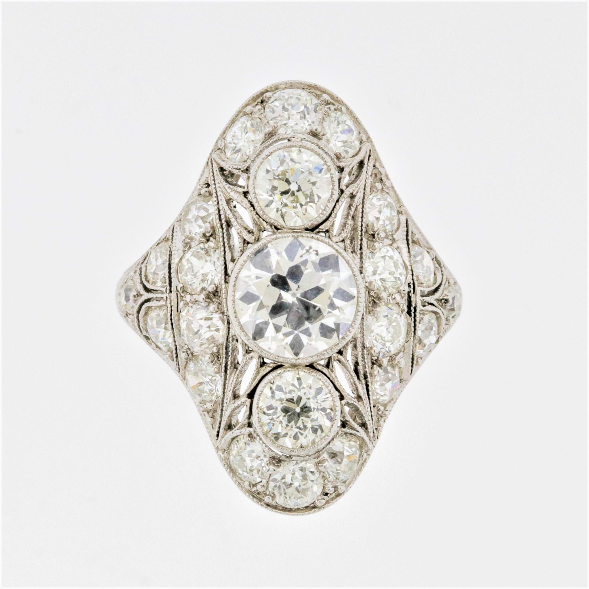 A lovely treasure from the Art Deco era, circa 1930. It features a 1.25 carat European-cut diamond in its center which is bezel set along with two other diamonds above and below it. They have detailed hand applied millgrain around the settings in