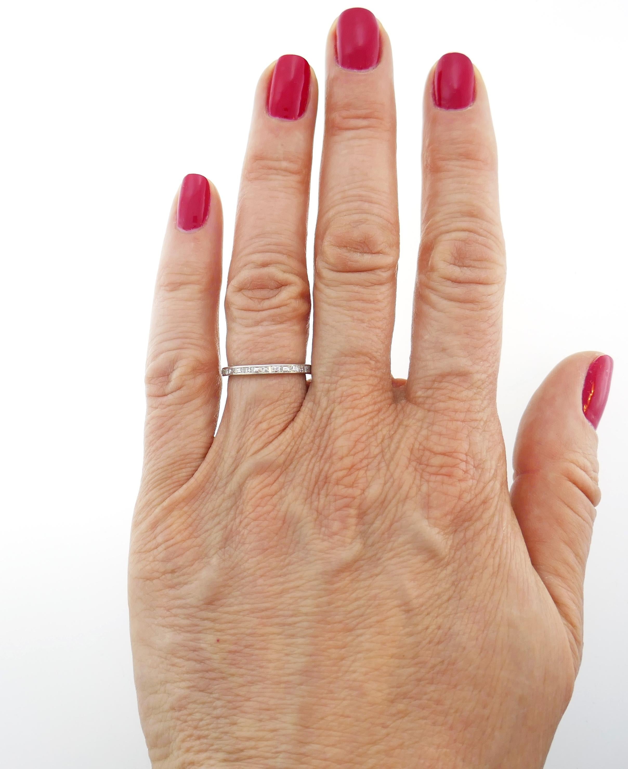 Exquisite Art Deco platinum band set with twenty nine beautiful rectangular and square table cut diamonds approximately from 0.01-ct to 0.03-carat each, total weight 0.68 carat.
The band is size 5.75 and is 2 mm wide. Weight 1.5 grams.