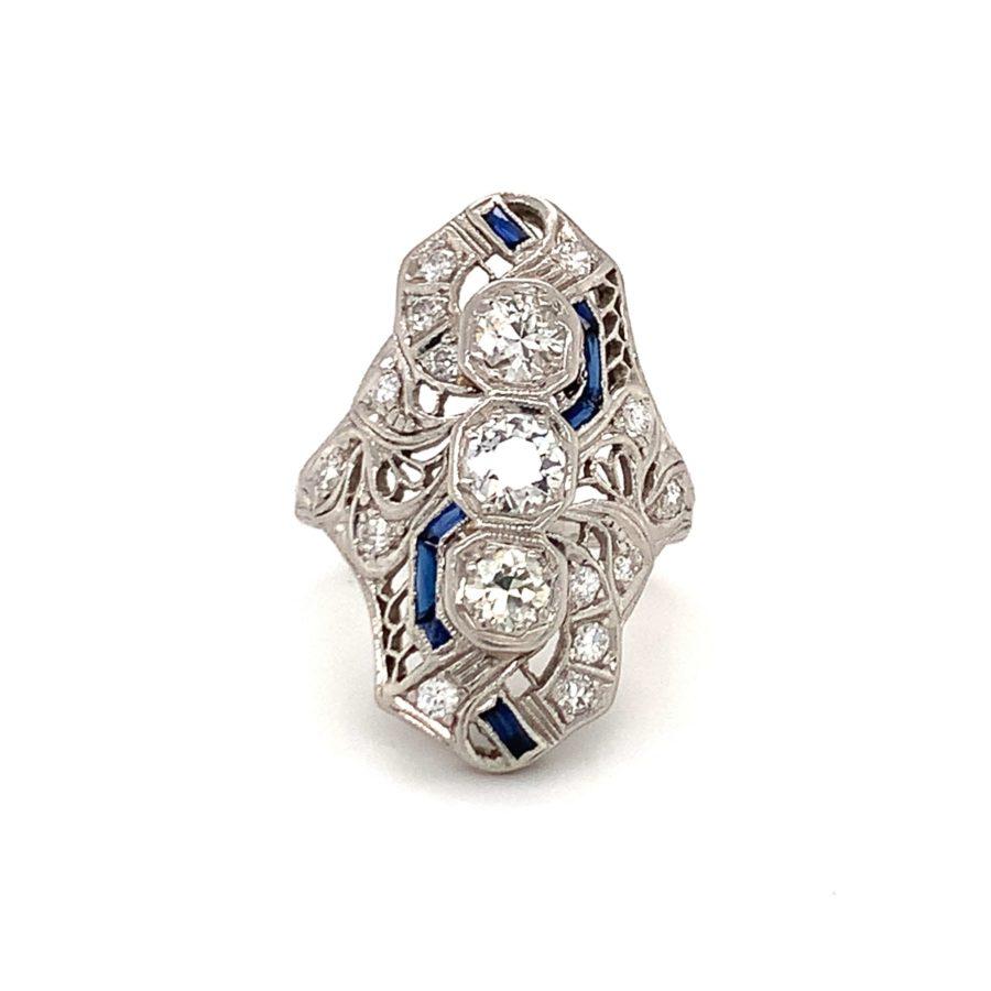 Art Deco diamond platinum filigree ring featuring 20 old European and round cut diamonds totaling 1.25 ct. further accented with 8 french cut synthetic blue sapphires.

Magnetic, heirloom quality, divine.

Additional information:
Metal: