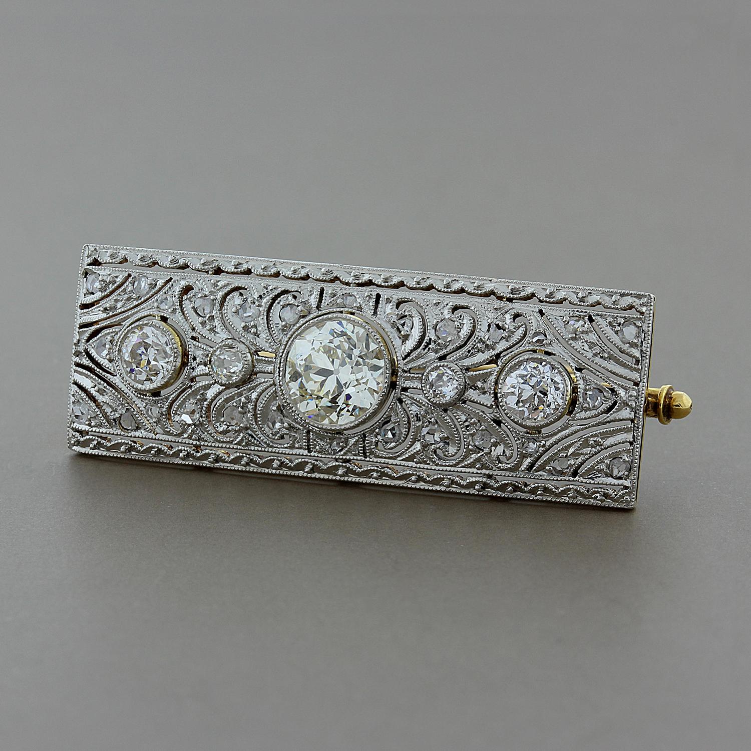 This early 20th century brooch from the Art Deco era features a 0.95 carat European cut diamond at the center, which is enhanced by 0.45 carats of European cut and rose cut diamonds. Set in 14K yellow gold with a platinum top.

Brooch Length: 1 7/16