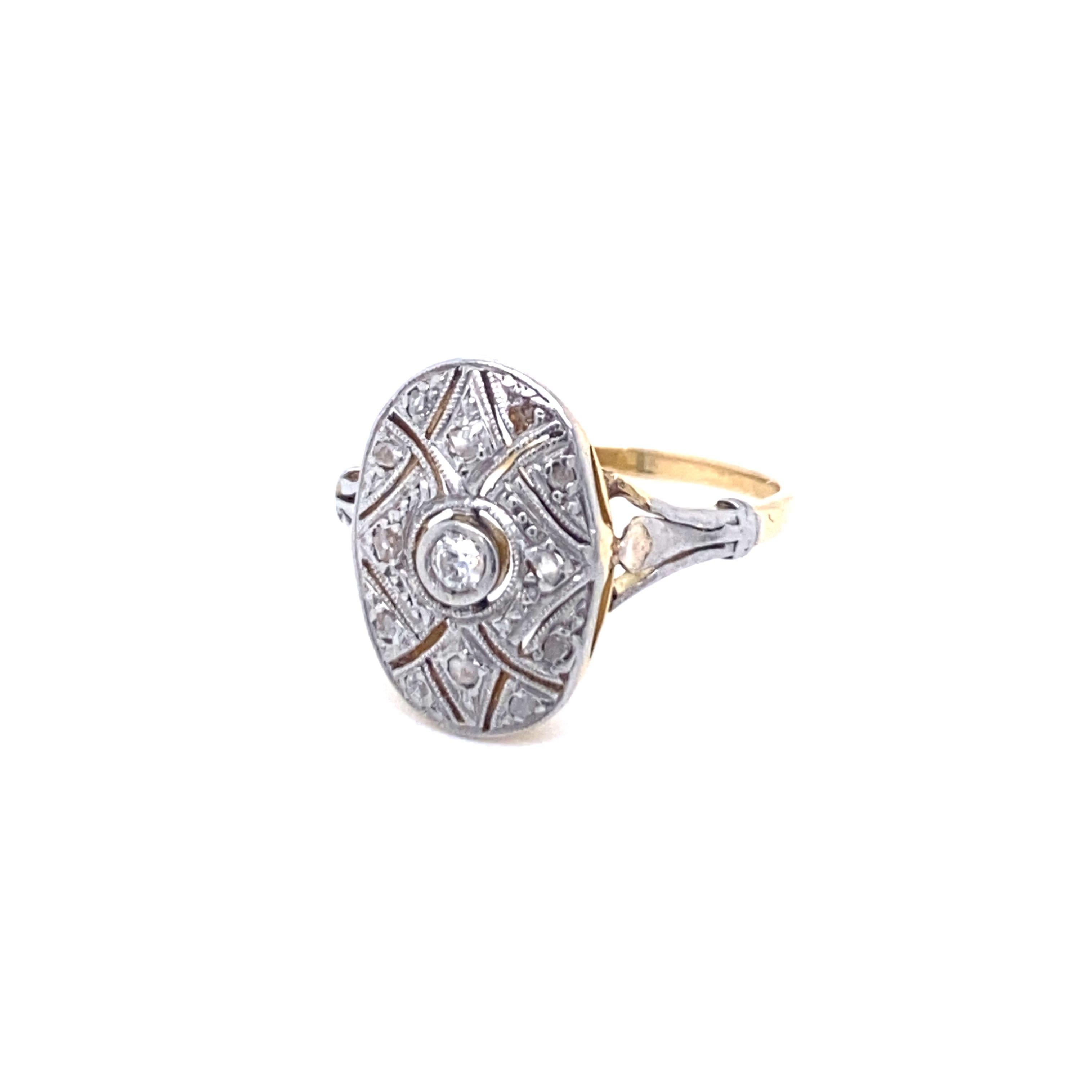 Classy and timeless Art Deco Platinum and 18k gold ring, it is set in the center with an old cut diamond of 2mm and Surrounded by 12 rose cut diamonds of 1 mm. Total diamond wight 0.25 carats
Very nice work on the Oval platinum tray, ful Art Deco,