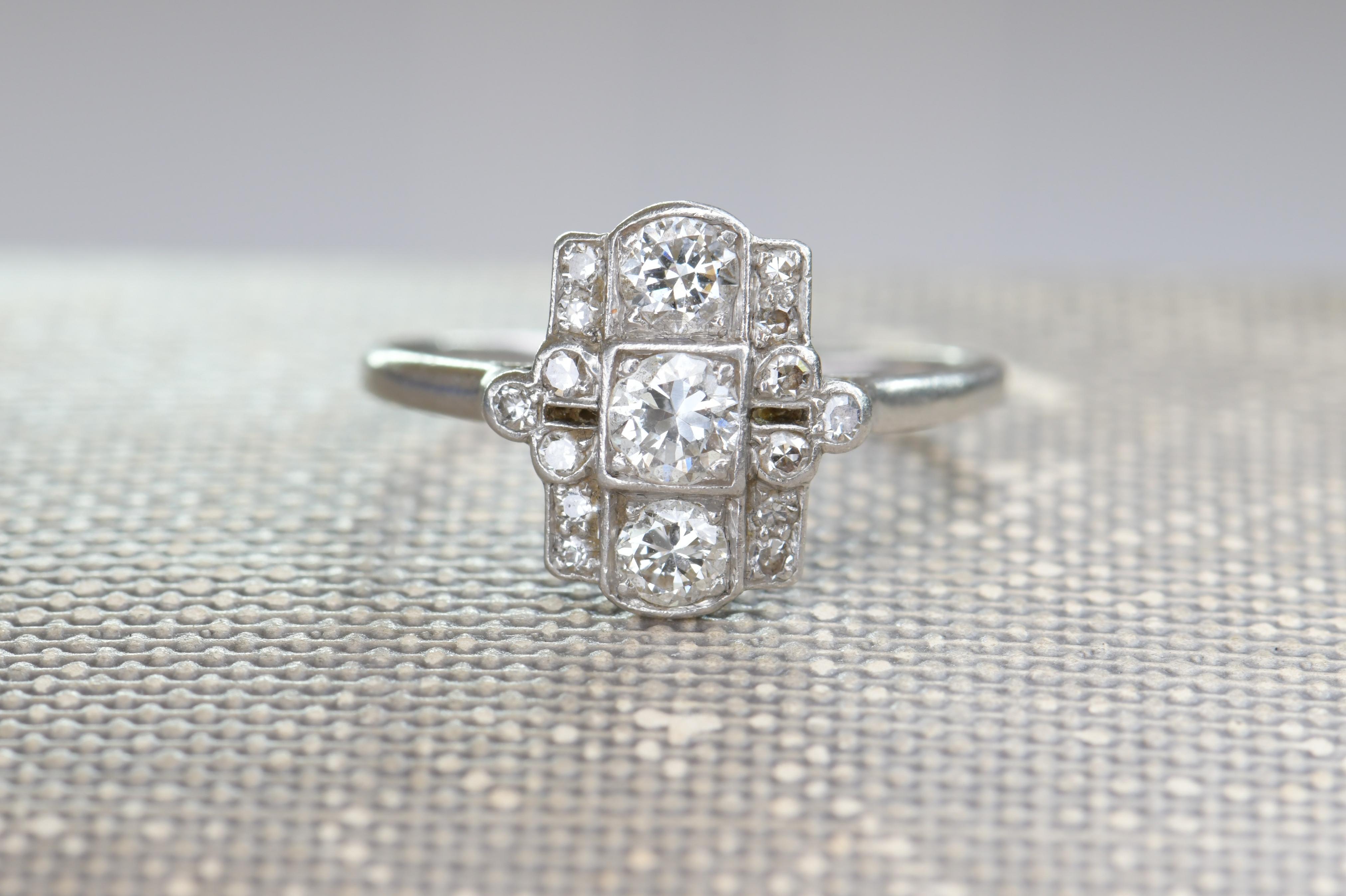 A wonderful platinum ring that is typical of the Art Deco period with it’s smart design. It is a pleasing rectangle shape that is very flattering to the finger when worn. Down the center are set three well matched white diamonds in open settings.