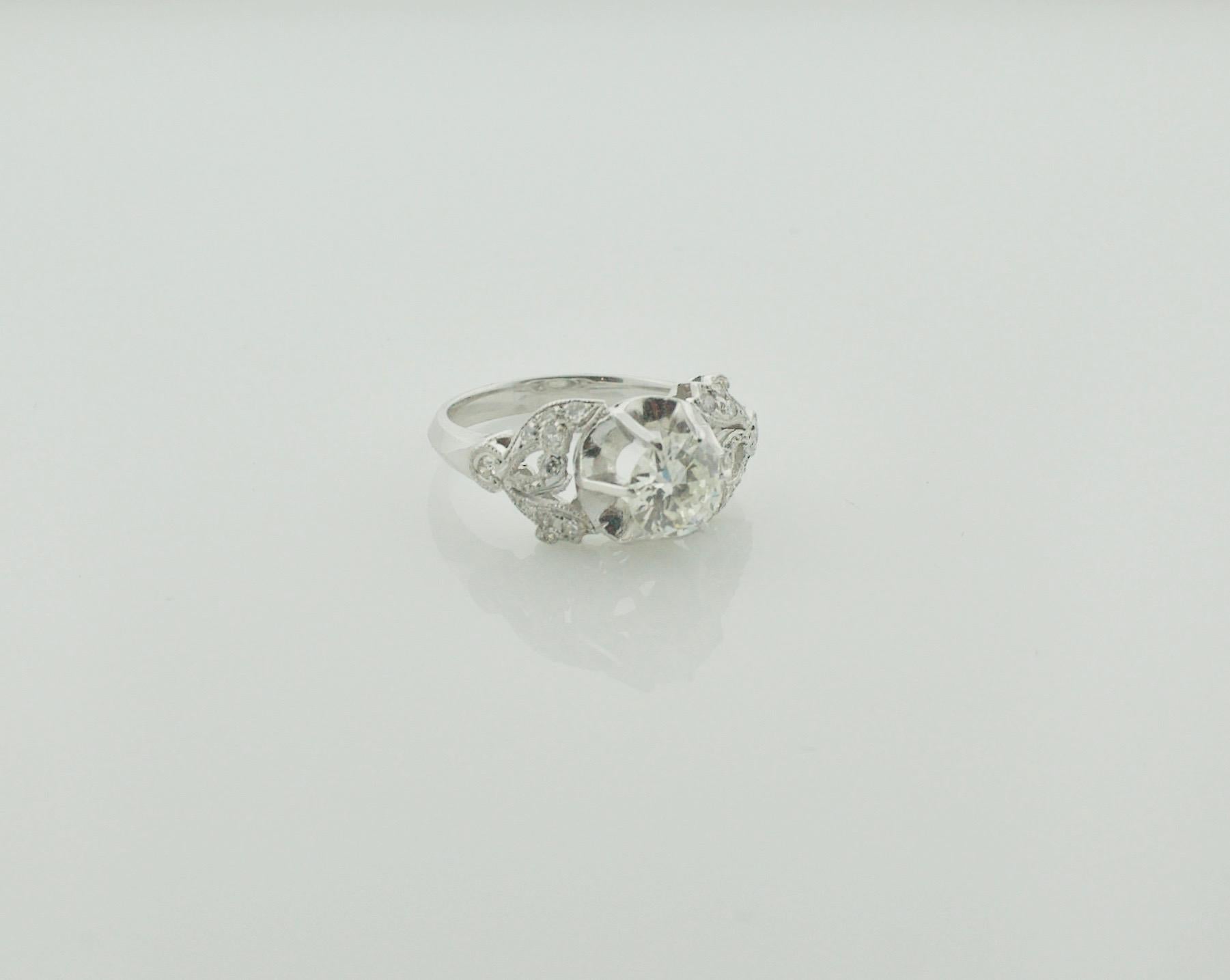 Art Deco Diamond Platinum Solitaire Ring Circa 1930's
One Old European Cut diamond Weighing .87 [K SI1]
18 Round Cut Diamonds Weighing .35 Carats Approximately 