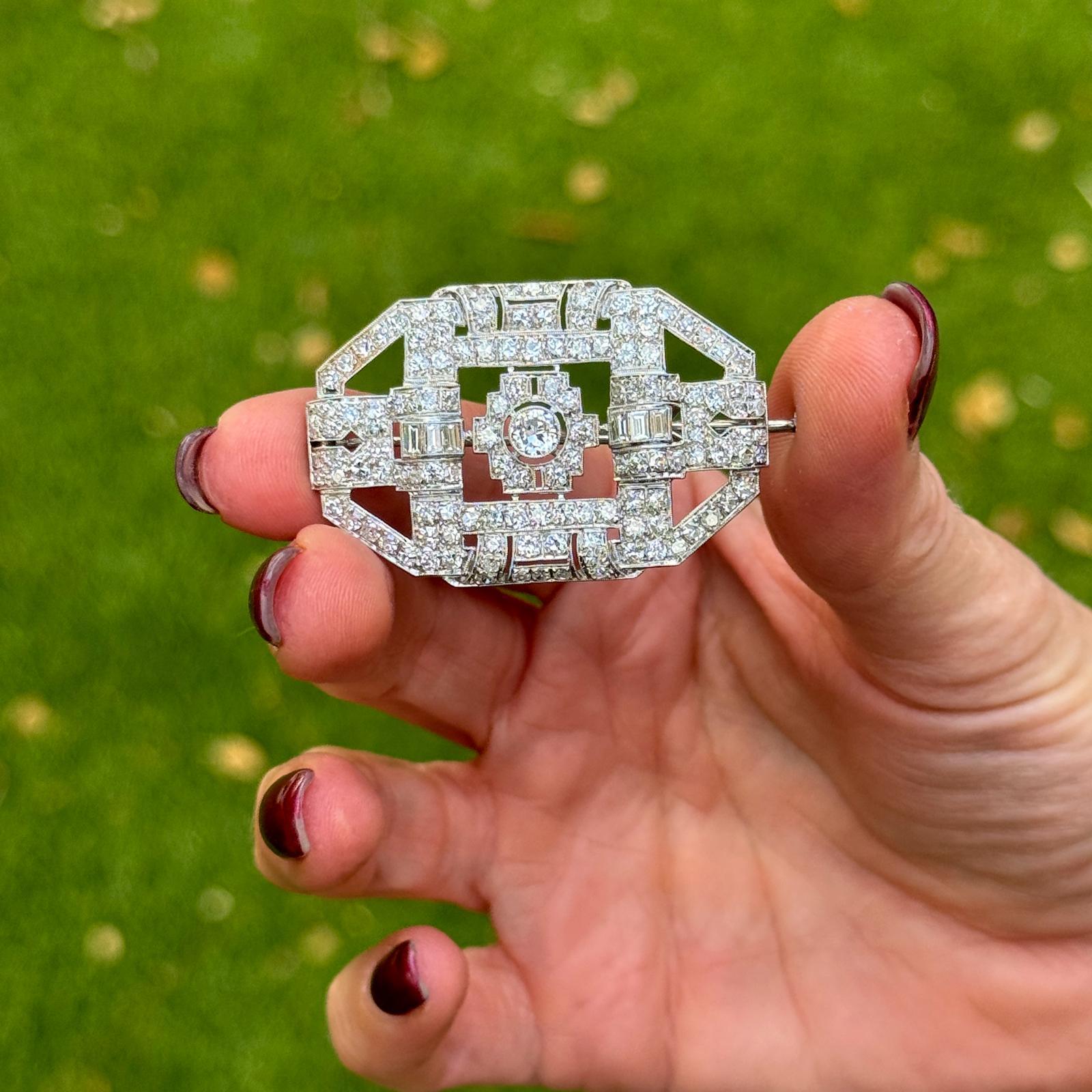 This exquisite Original Art Deco Platinum Diamond Brooch features a striking combination of Old European Cut, Single Cut, and Baguette Cut diamonds, totaling approximately 4 carats in weight. The diamonds are graded G-H color and VS2-SI1 clarity.