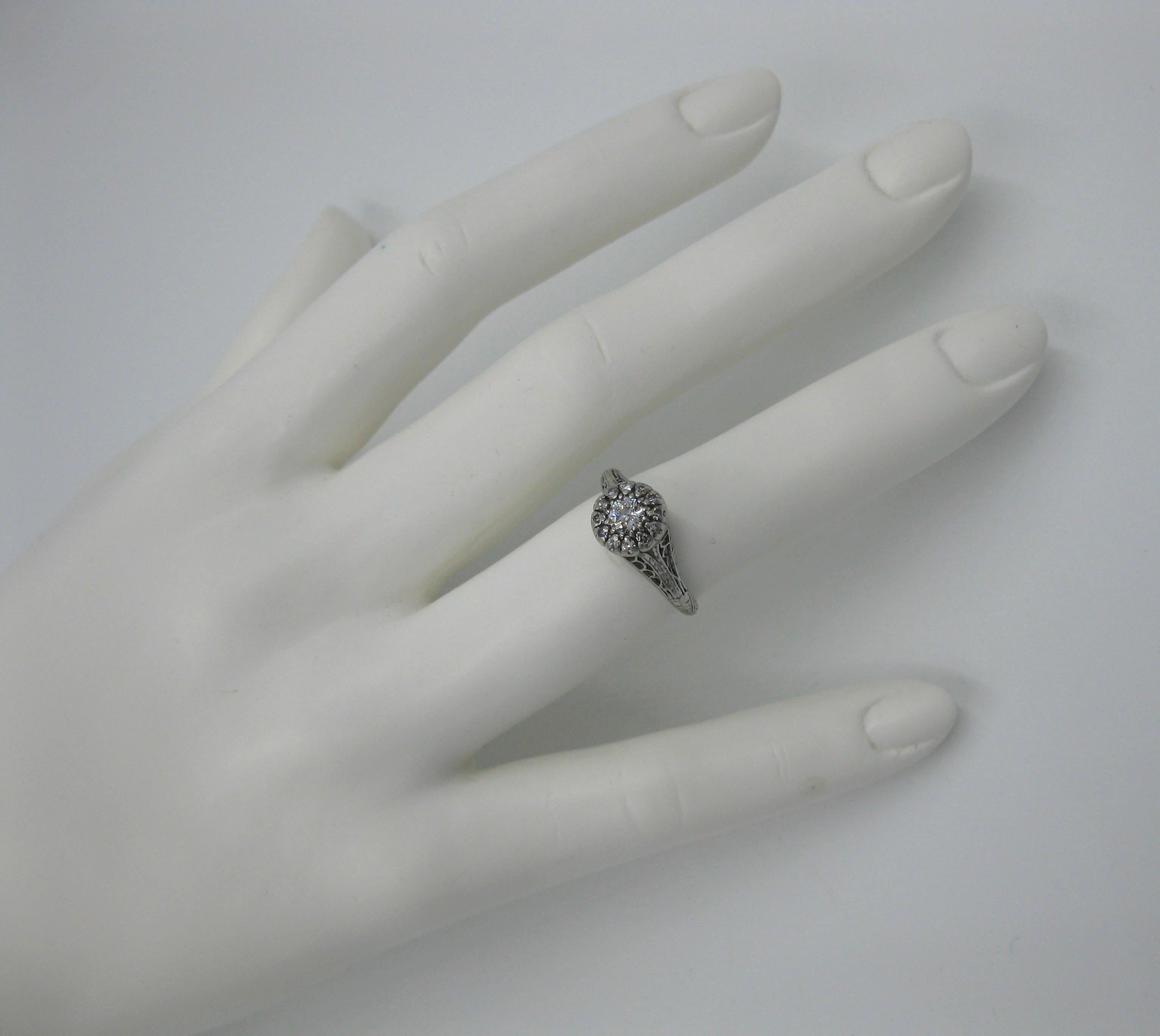 A stunning Antique Art Deco - Edwardian Diamond Ring in Platinum with a spectacular .20 Carat Old European Cut Diamond of gorgeous F-G-H color (white!) and VS clarity.  The diamond set in Platinum and surrounded by 12 additional diamonds for a total