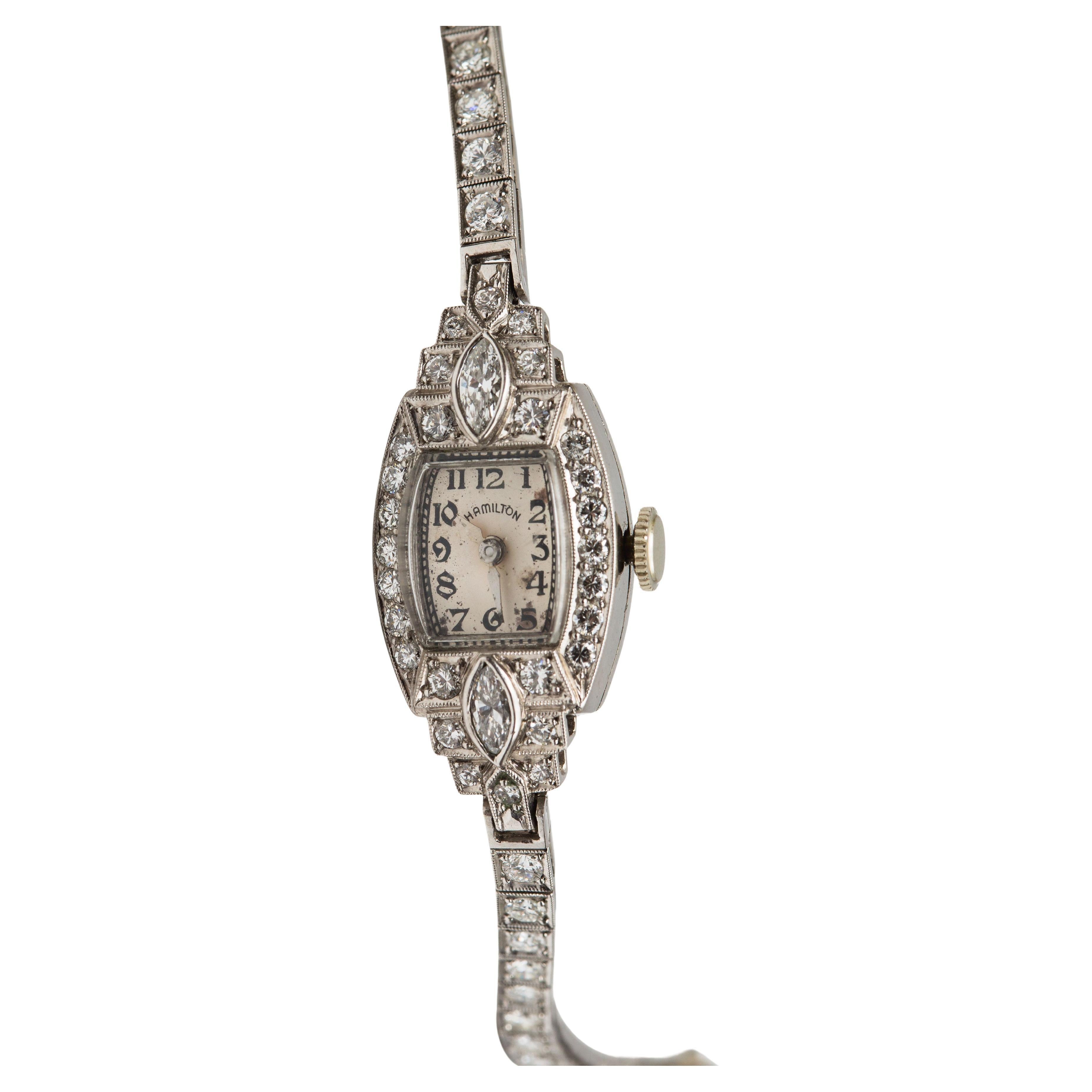 Material: Platinum
Gemstone: Diamond 3 cttw (Transitional Cut)
Weight: 20 grams
Size: 6.5 inches
Dimensions:
Watch Case 31 mm x 16.1 mm
Strap 3.3 mm wide

This beautiful antique watch crafted in platinum is decorated with 3 carats of transitional