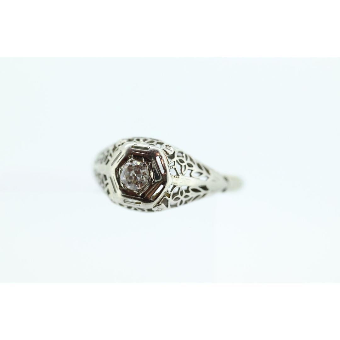 Vintage from the 1920s
Size: 7 1/2 US
Materials: Stone
Gemstone: Diamond
Gem Color: Colorless
Band Color: Silver

Style: Art Deco

Beautiful Filigree ring. 18k white gold. Amazing piece when worn.

Details:
1.9grams total weight
3.4mm diameter