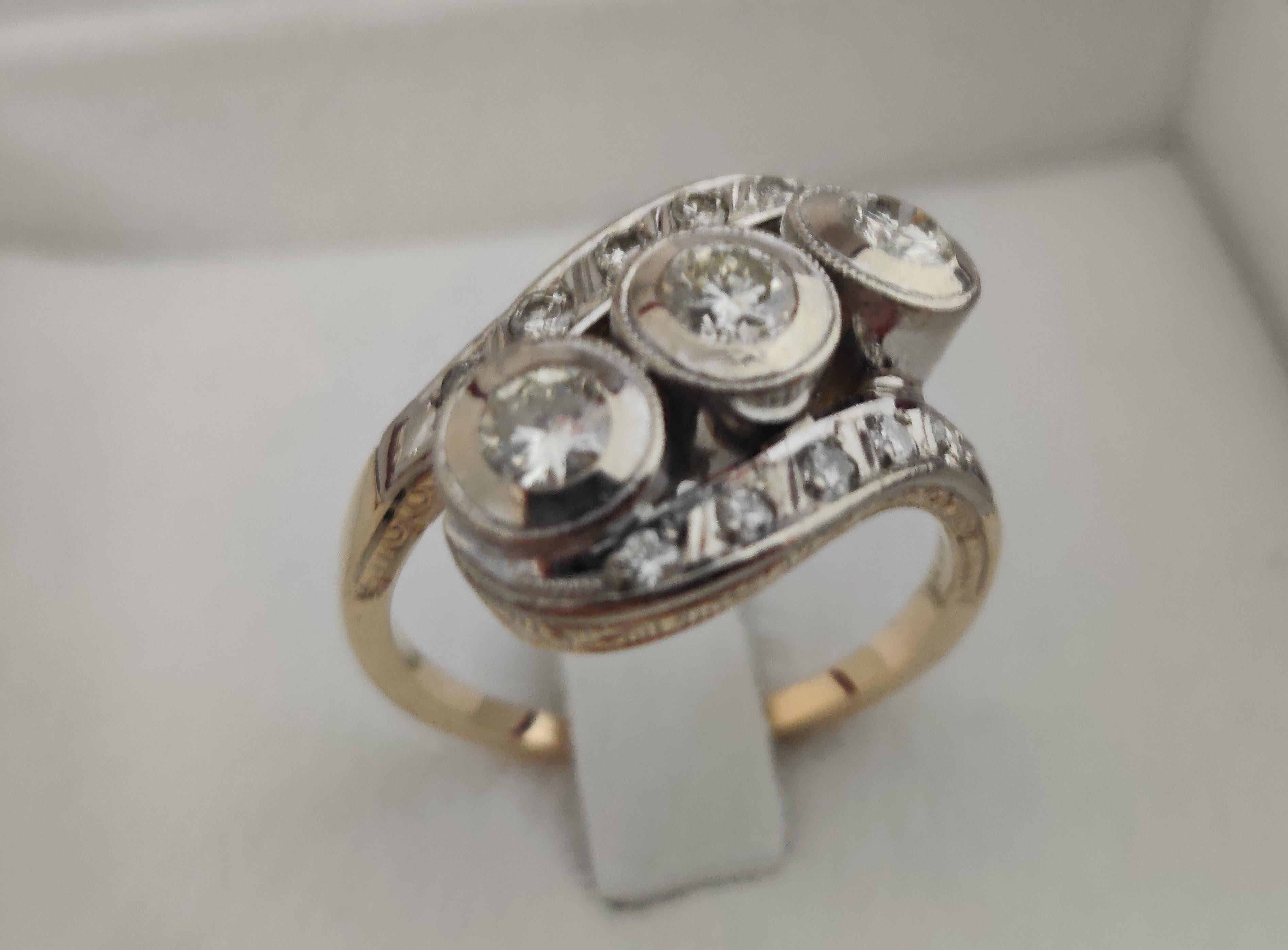 14 ct gold on top platinum 
hallmarked 585 (for Europe)
ca. 0,50 ct diamond
size 57
weight 6,9 grams