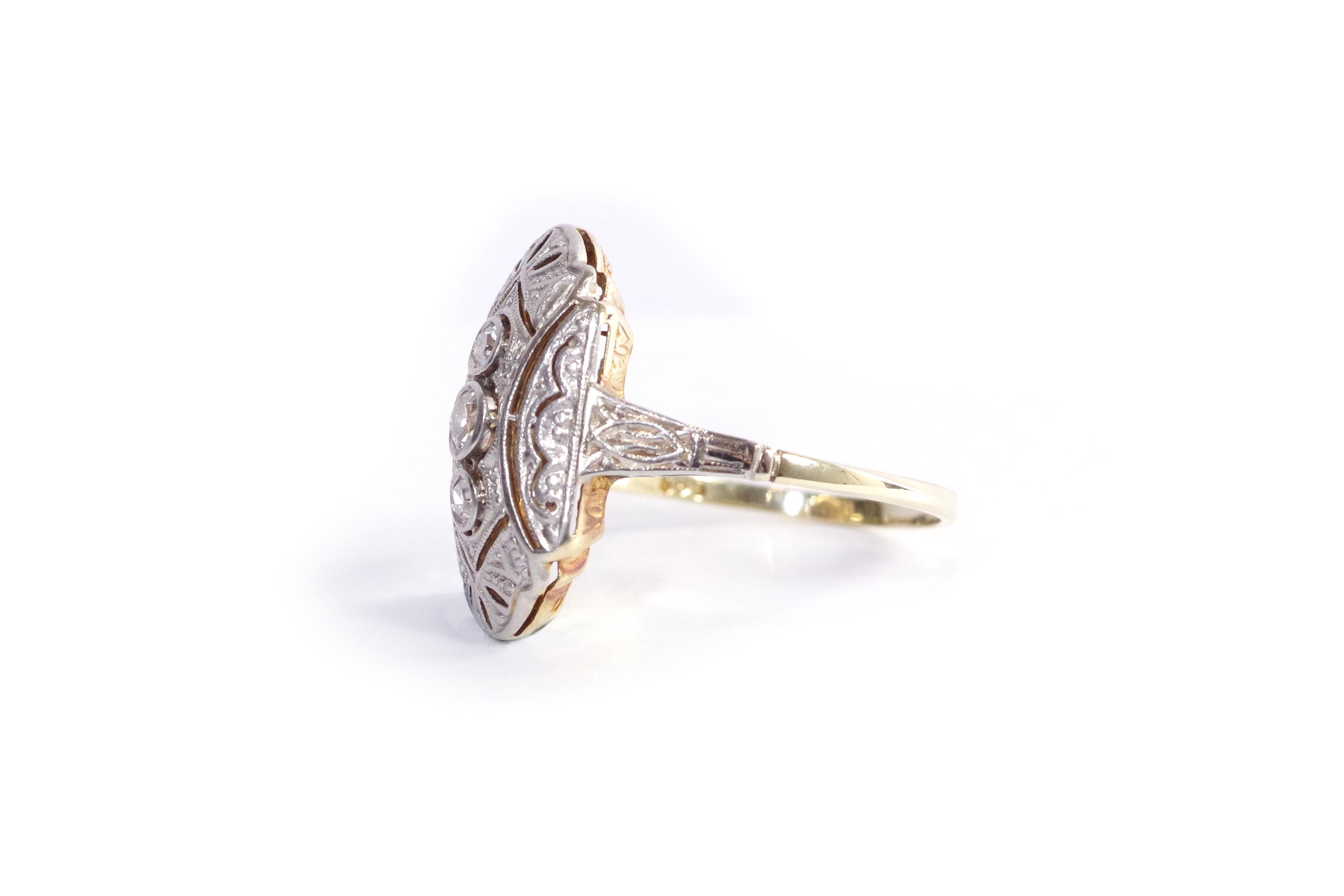 Art Deco diamond ring in 14-karat gold and platinum. Hexagonal Art Deco ring set with three old mine cut diamonds in a bezel setting. The ring is elegantly decorated with geometric lines and openwork motifs, typical of the Art Deco period. Antique