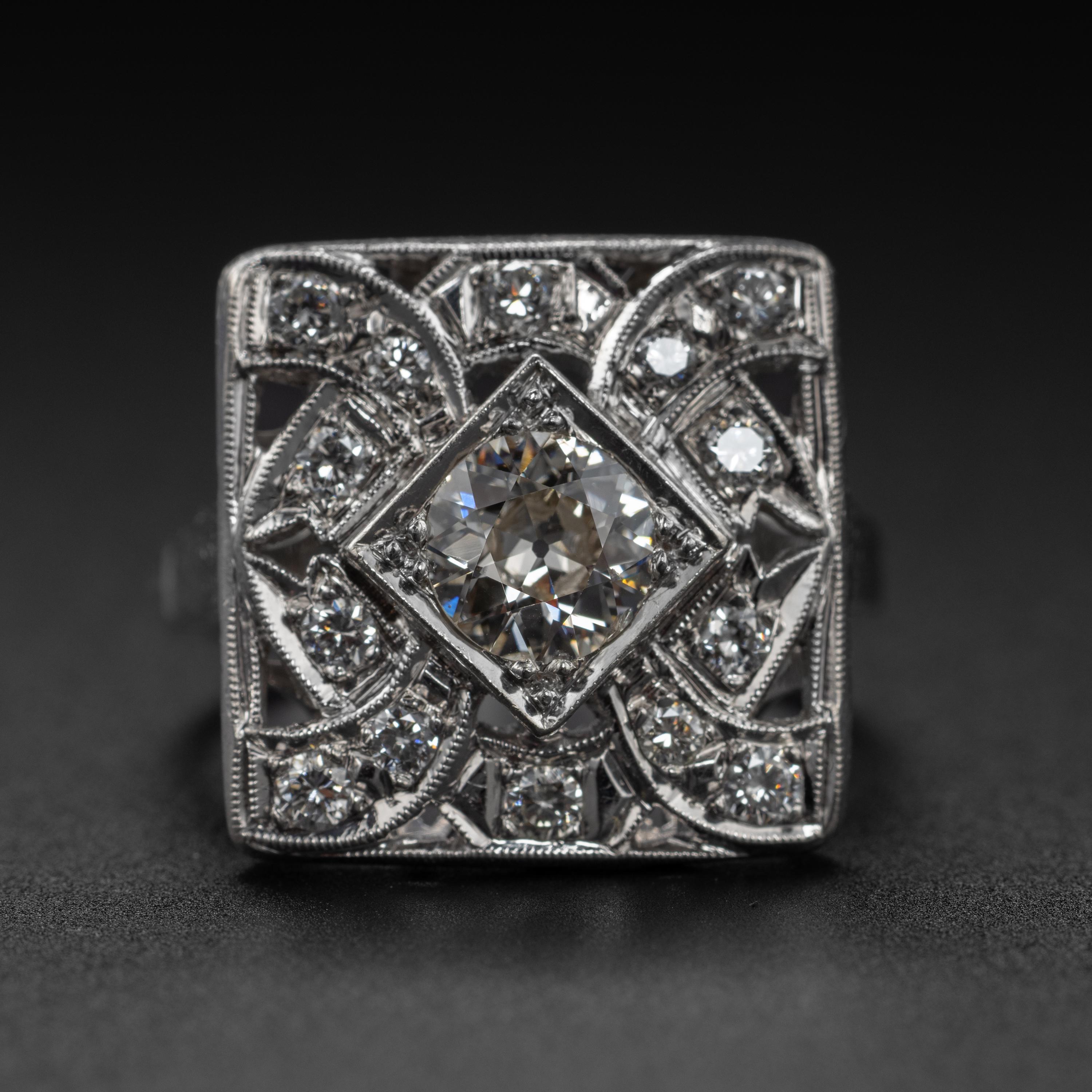Sleek and geometric, this quintessential Art Deco diamond ring features a 1 carat very light yellow (N) eye-clean old European cut diamond in the center, surrounded by a constellation of fourteen smaller bright and white old European cut diamonds