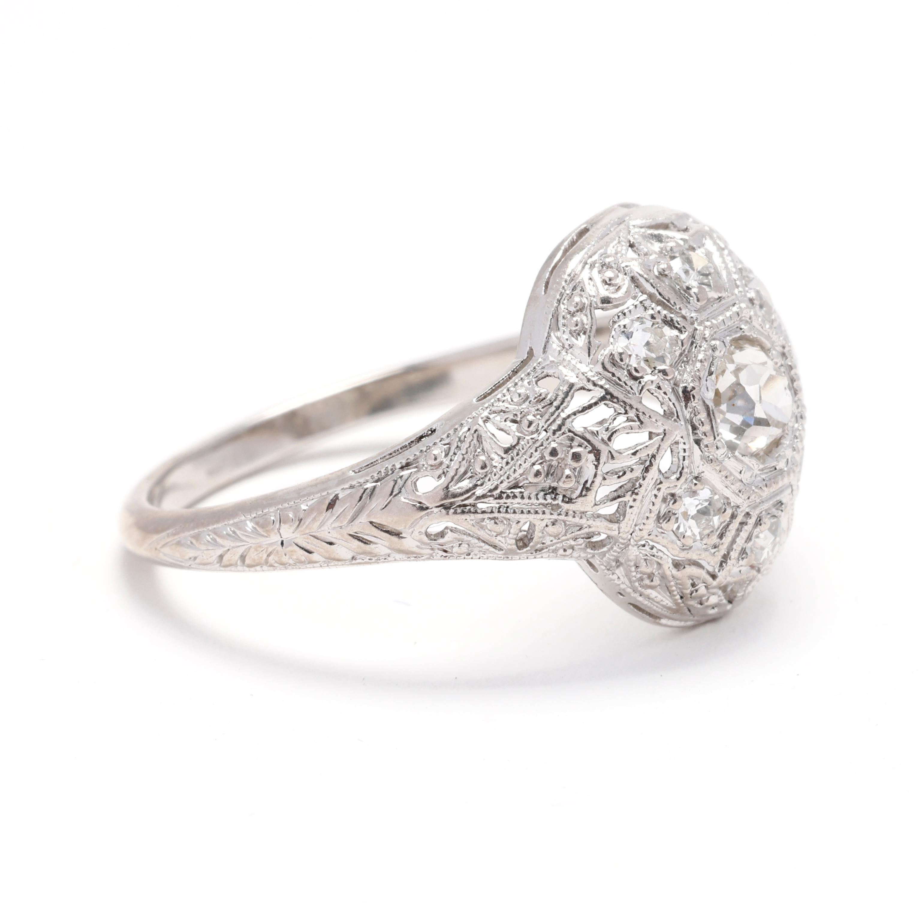 Replongez dans l'élégance de l'époque Art déco avec cette superbe bague en diamant, réalisée dans une luxueuse combinaison de platine et d'or blanc 18 carats. Cette bague de taille 6 est ornée de diamants éblouissants sertis dans un motif complexe