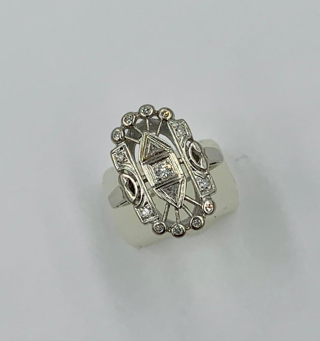 This is a stunning Art Deco style Diamond Ring with Trillion Cut Diamonds in a 14 Karat White Gold Open Work setting of great beauty.  The ring is such a special Art Deco style Jewel and rings with cutting edge Art Deco design are rare and highly