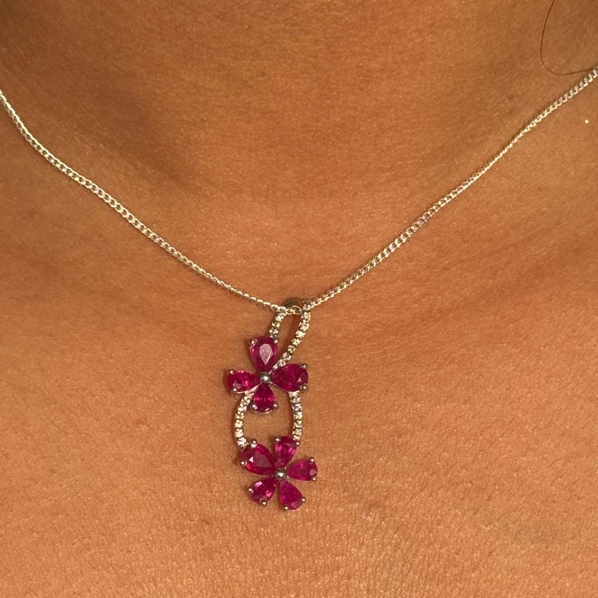 Modern Diamond Ruby Floral Love Pendant in 925 sterling silver studded with pear cut ruby and round cut diamonds. This stunning piece of jewelry instantly elevates a casual look or dressy outfit.
Ruby brings energy, calmness and happiness into life.