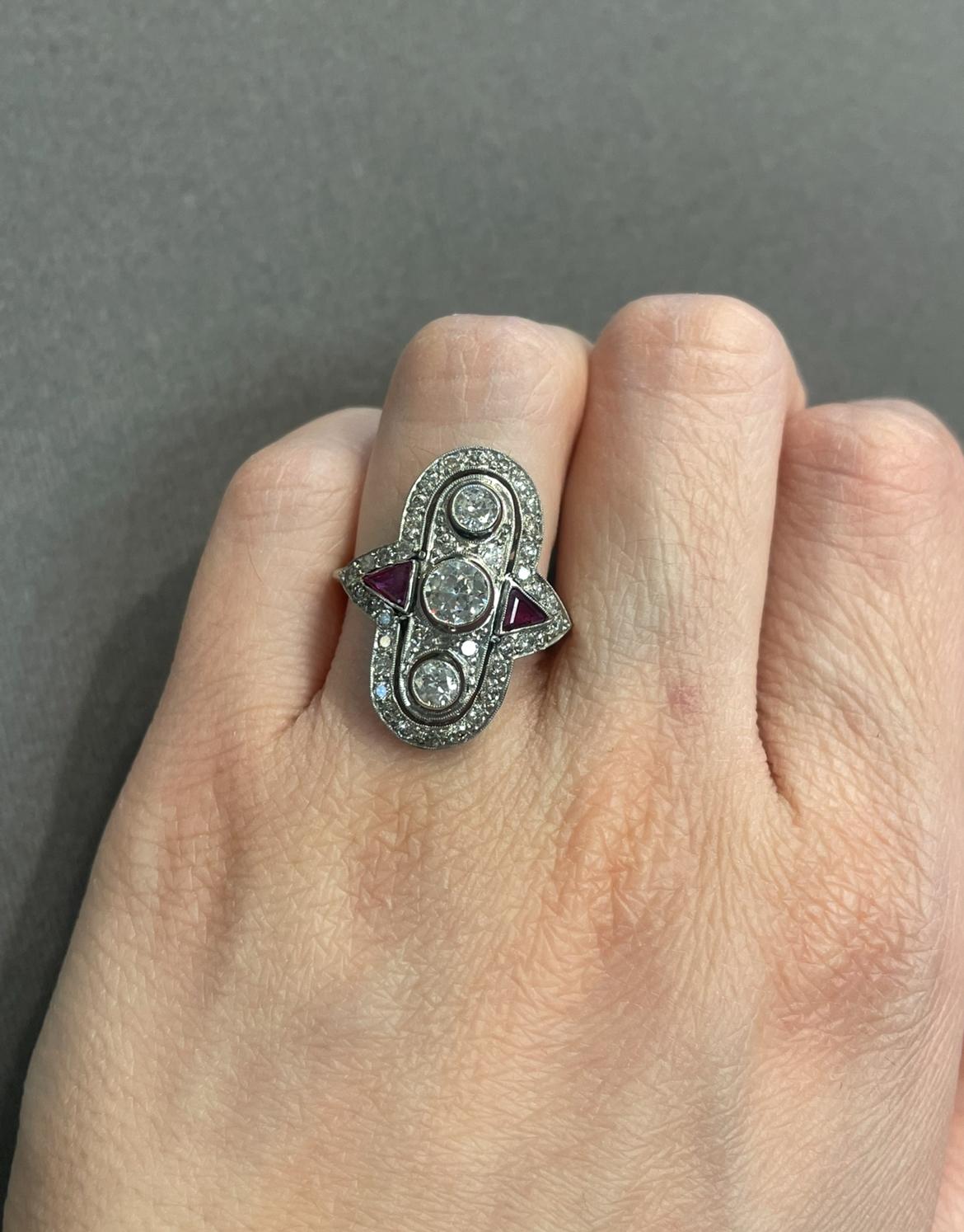 Art Deco Diamond & Ruby Navette Ring

A ring set with diamonds & two triangle cut rubies.

Approximate diamond weight: 1.10 carats 
Approximate ruby Weight: .30 carat
Ring Size:  6.5
Complimentary Resizing 
Metal Type: Platinum

