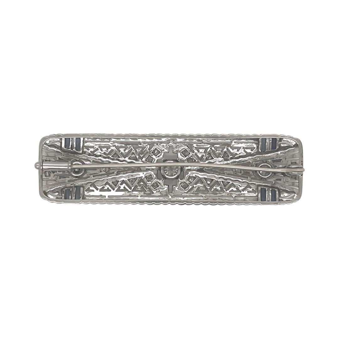 ITEM: Brooch or Hair Barrette

PERIOD: Art Deco (1920s)

METAL: 14K WHITE GOLD

STONES: Diamonds and Sapphires

CUT: Old European cut Diamonds and Baguette Sapphires

CARAT WEIGHT: Diamonds approx 0.8cts
                            Sapphires approx
