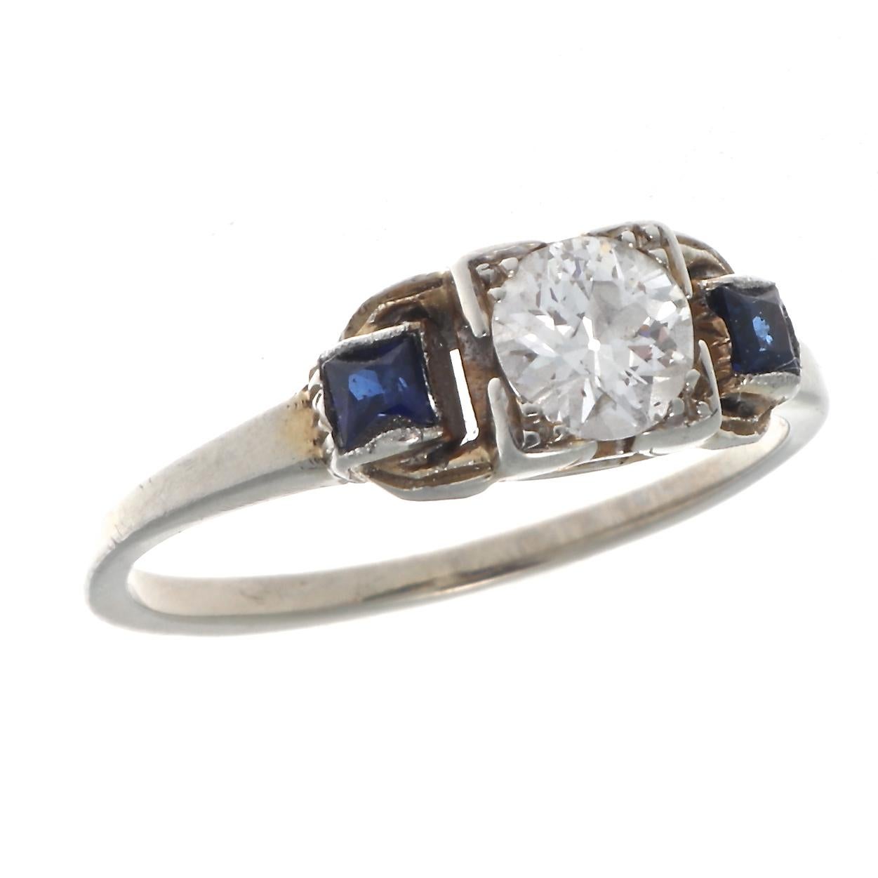 As timeless as an everlasting marriage, a uniquely understated approach to art deco design from the 1920's.  Featuring an old European cut diamond nestled between shoulders of royal blue natural sapphires. Crafted in 14k gold. Ring size 5-3/4 and