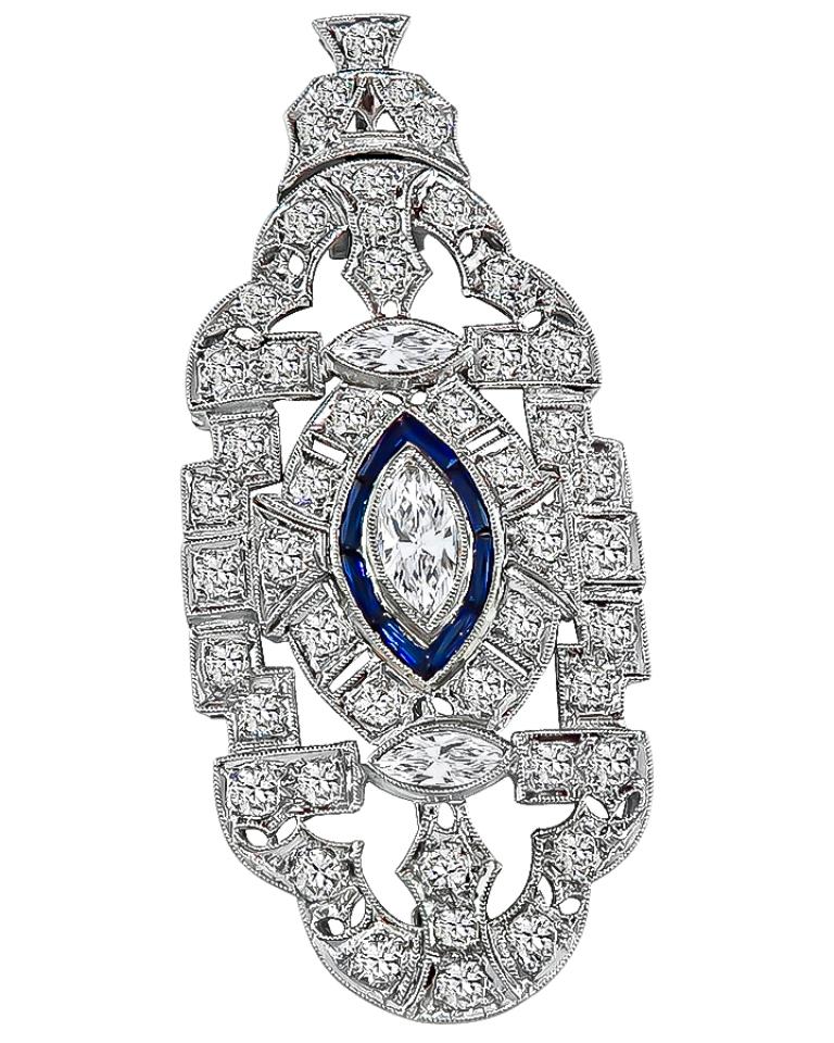 This elegant platinum pendant / pin from the Art Deco era is set with sparkling marquise and round cut diamonds that weigh approximately 2.00ct. graded G color with VS clarity. The diamonds are accentuated by lovely sapphire accents. The pendant