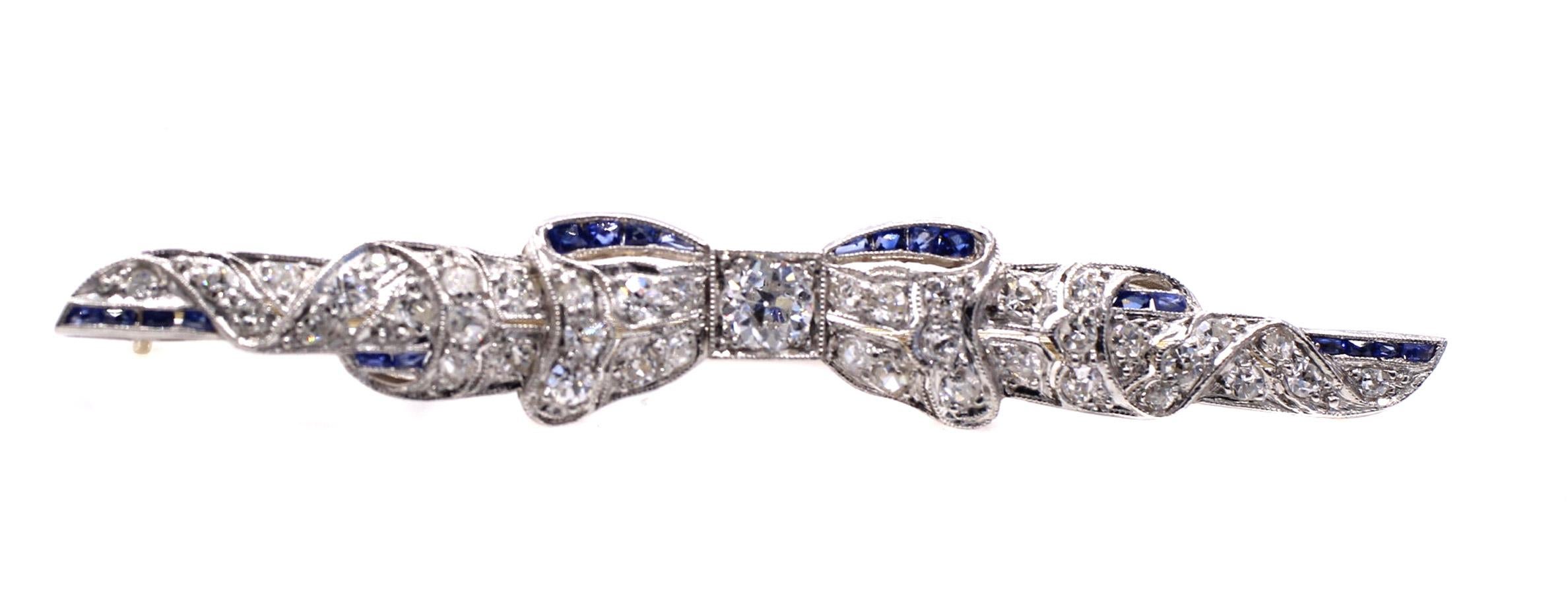 Beautifully designed and masterfully handcrafted in platinum, set with bright white and lively Old European cut diamonds and embellished with deep blue calibre sapphires.