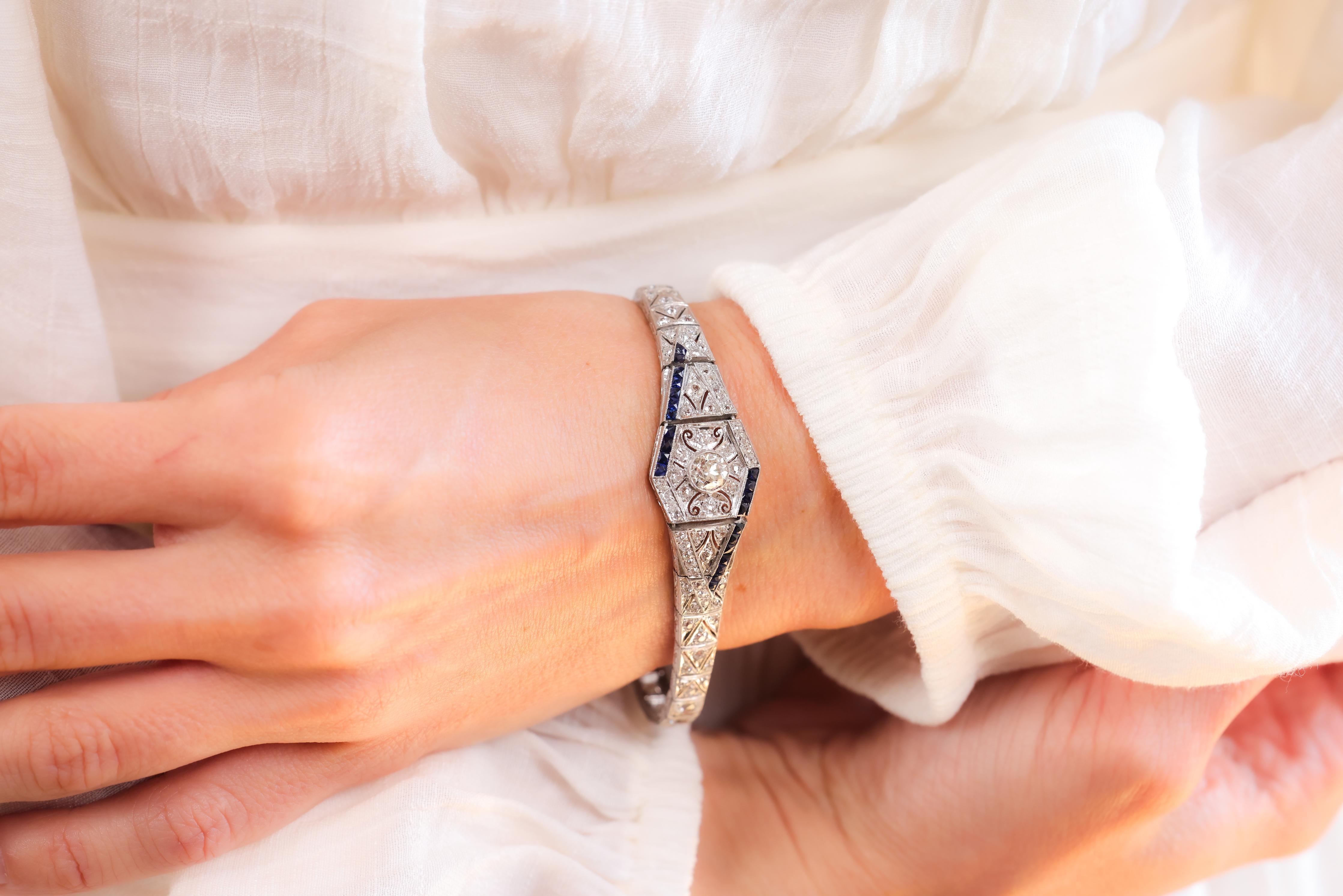 Center Stone: Diamond
Cut: Old European
Weight: Approximately .7 Carats
Color: J-K
Clarity: SI
Accent Stone: 18 Diamonds
Cut: Old European
Weight: Approximately 3.00 Carats
Color: I
Clarity: SI
Accent Stone: 22 Sapphire
Cut: French Cut
Weight: