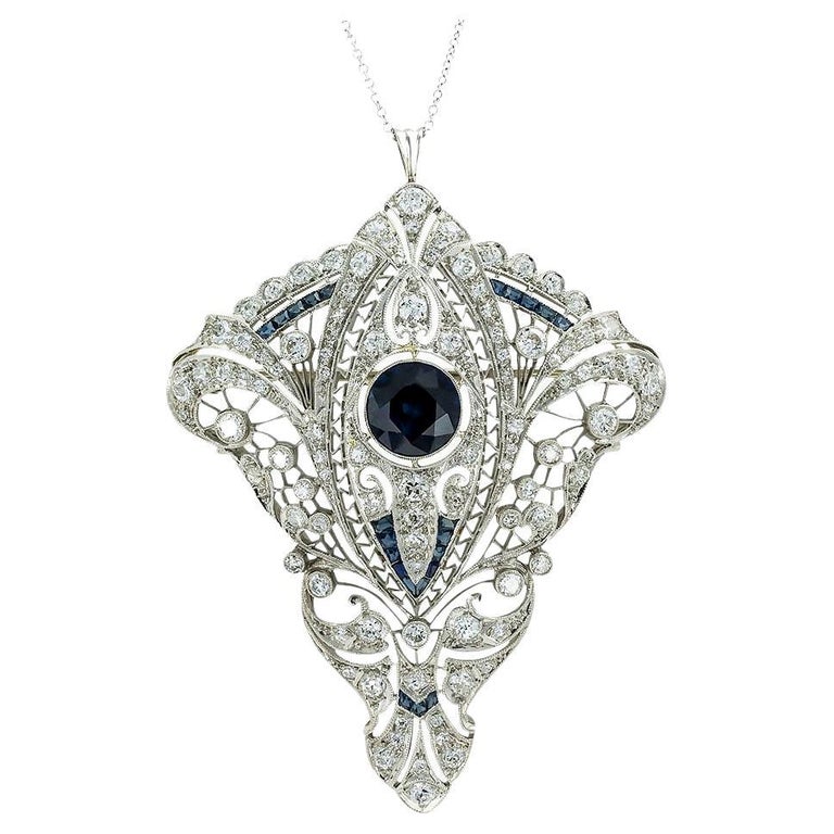 Art Deco diamond sapphire and platinum filigree brooch pendant circa 1920. *

SPECIFICATIONS:

DIAMONDS: one hundred old European-cut diamonds totaling approximately 3.75 carats, approximately G-I color, VS clarity.

GEMSTONES:  Sapphires weighing