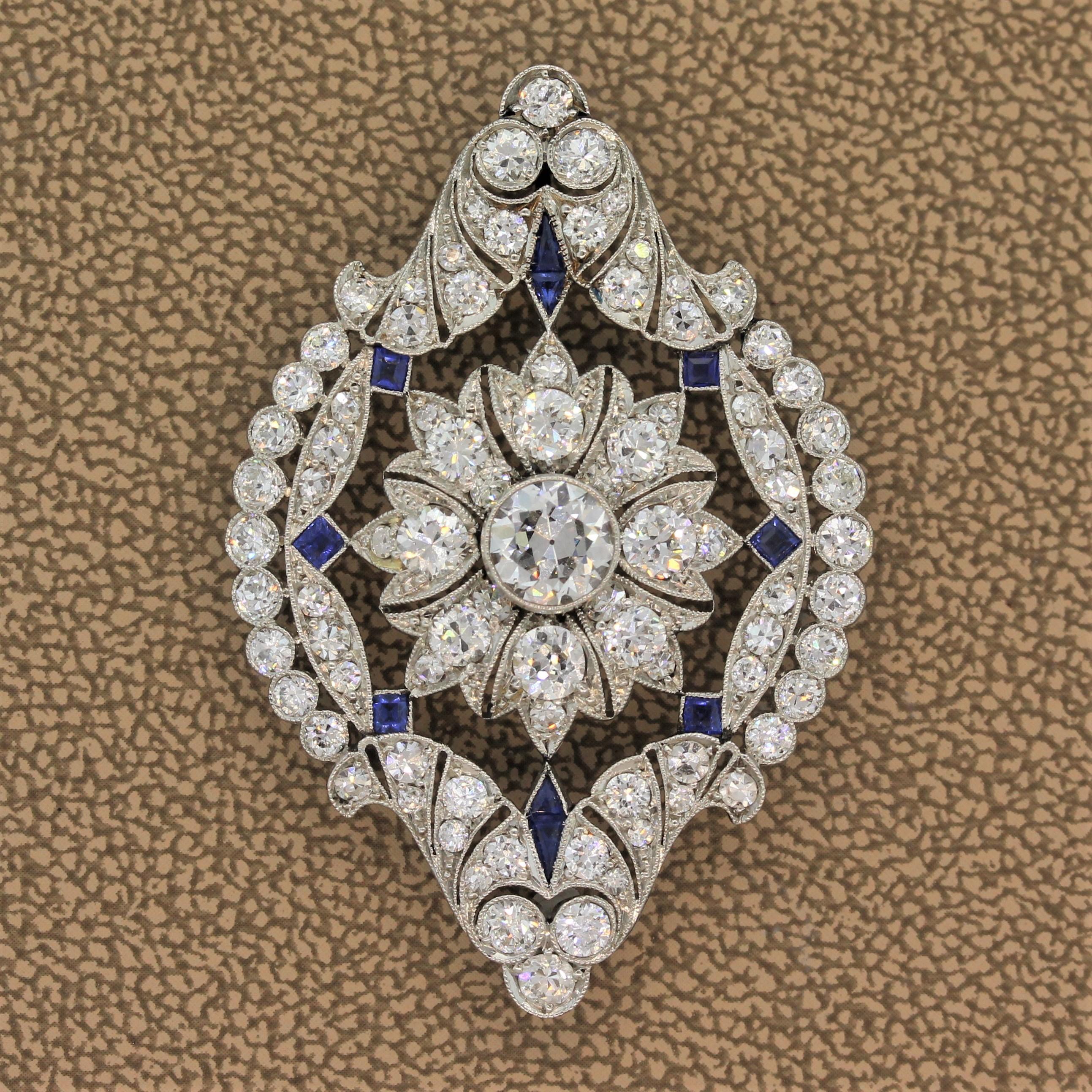 An exceptional pendant from the 1920’s featuring a 0.90 carat center diamond with an additional 3 carats diamonds throughout the pendant. Adding color to the piece are 0.50 carats precision cut of blue sapphires. A classic Art Deco with geometric