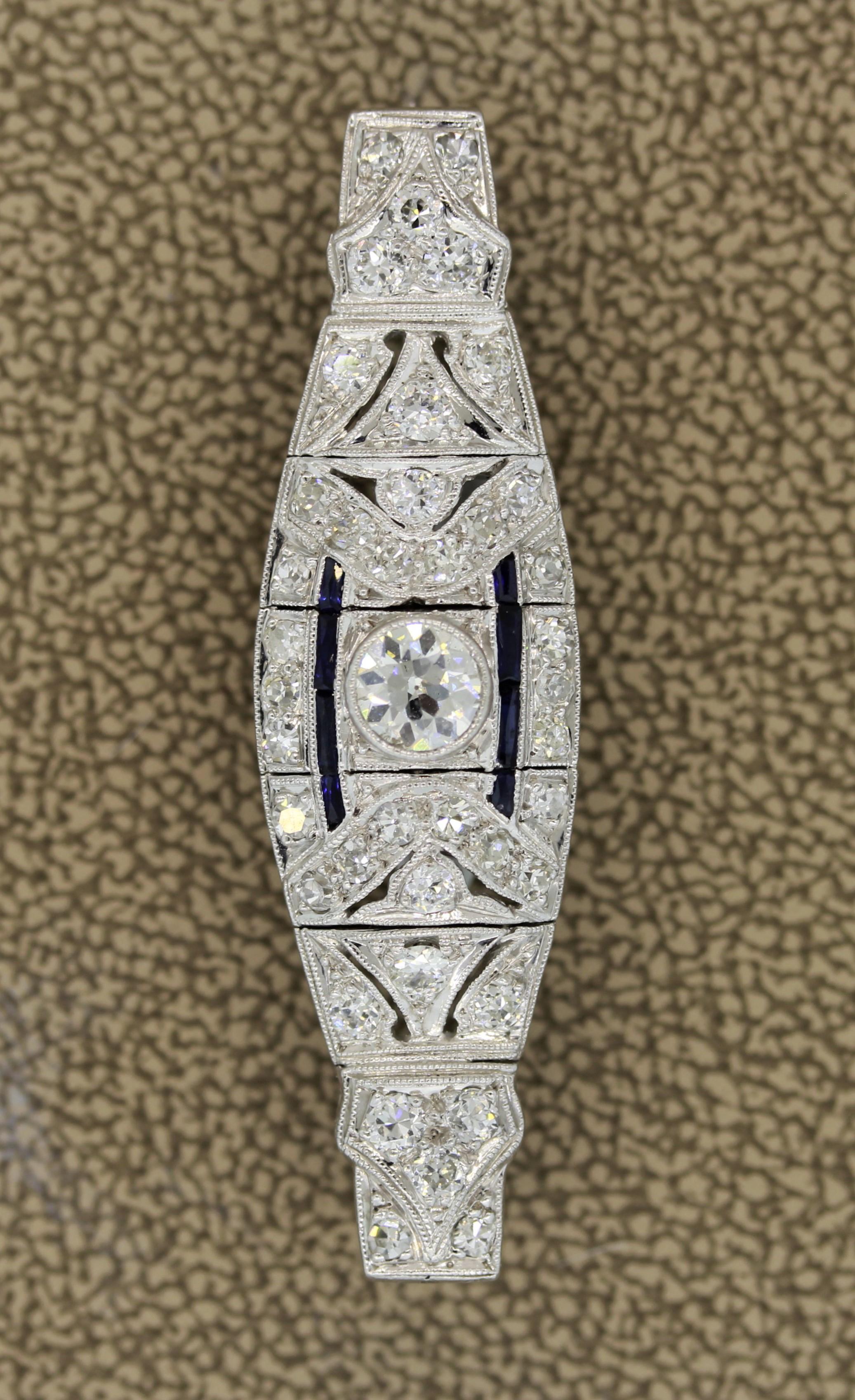 A lovely piece from the Art Deco era, circa 1925. It features a European cut diamond set in the center weighing 0.55 carats. It is accented with an additional 1 carat of smaller European cut diamonds set around the piece with blue sapphires as well.