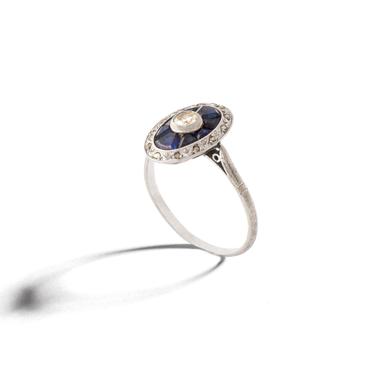 Art Deco Diamond and calibrated Sapphire on Platinum Ring.
Diamond estimated weight 0.37 carat.
Round cut. Estimated to be L-M color and Si clarity.
Diamond diameter: approximately 4.65 millimeters.
Ring Size: 7 3/4.
Gross weight: 2.54 grams.