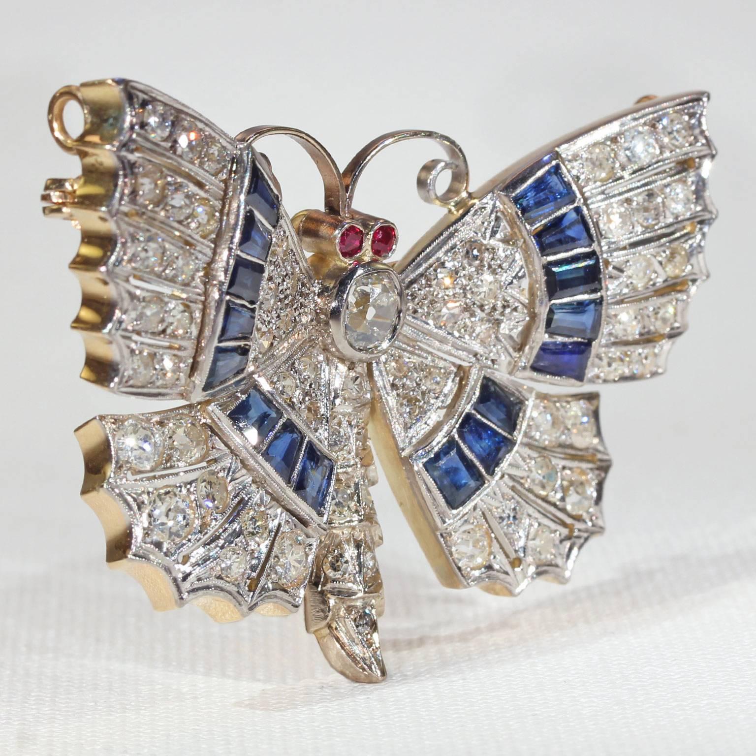 Hand crafted around 1930, this breathtaking butterfly brooch and pendant is done in 18 karat white and yellow gold; it showcases 63 Old European and brilliant cut diamonds that total approximately 3.85 carats. There are also 16 rectangular and