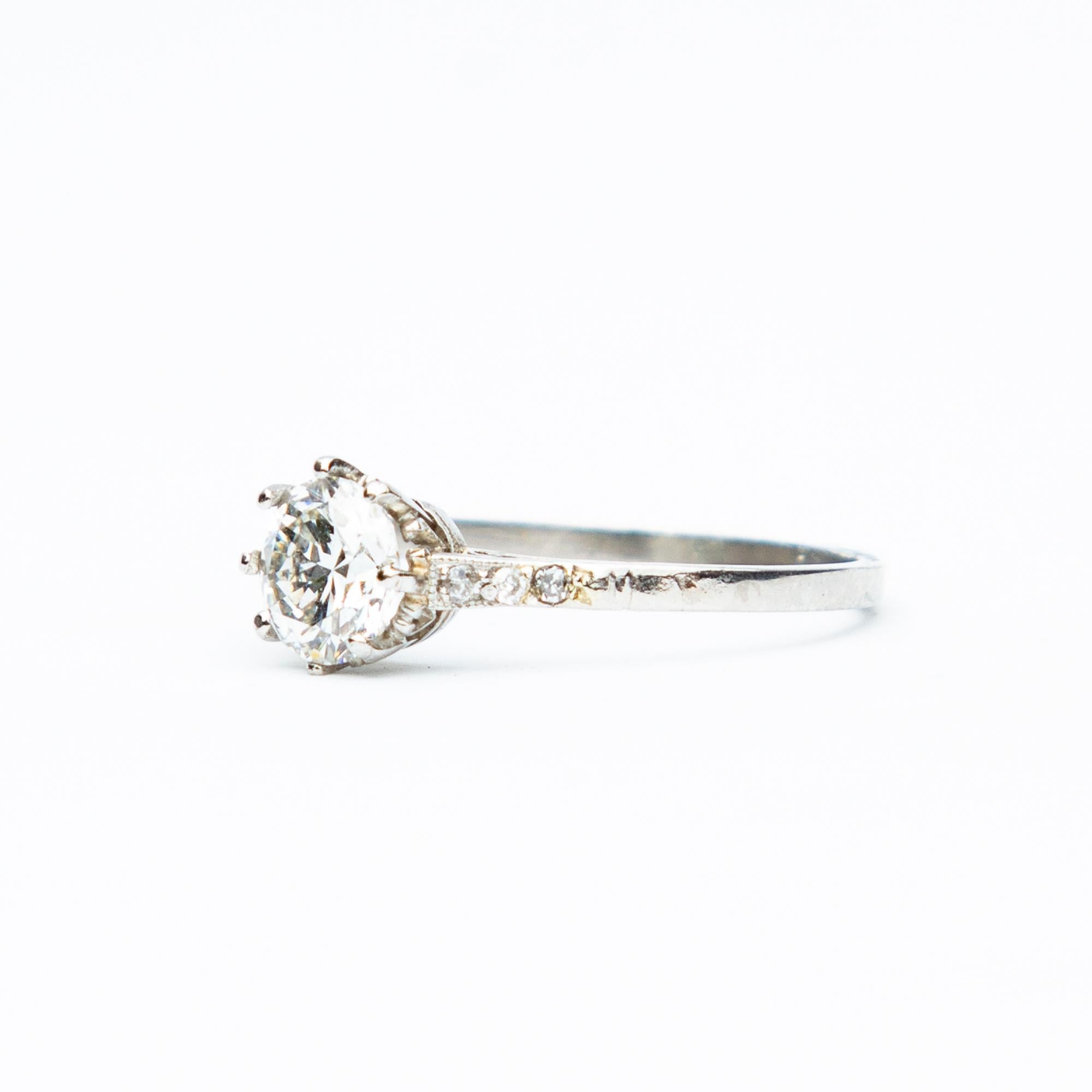 A magnificent example of an Art Deco Diamond solitaire ring, beautifully set with diamond shoulders in an eighteen carat white gold setting. The central Old European Cut diamond measures approximately 1 point 15 carats, G/H in colour and VS2/SI-1 in