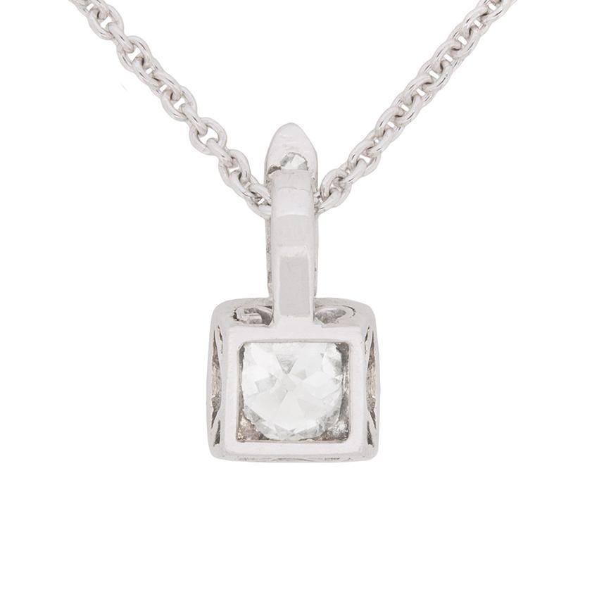This delicate pendant features a 0.61 carat old cut diamond which is a cushion cut. It is a H in colour and SI1 in quality and is grain set beautifully within a platinum collet. On the bail are a further three diamonds weighing 0.03 carat in total.