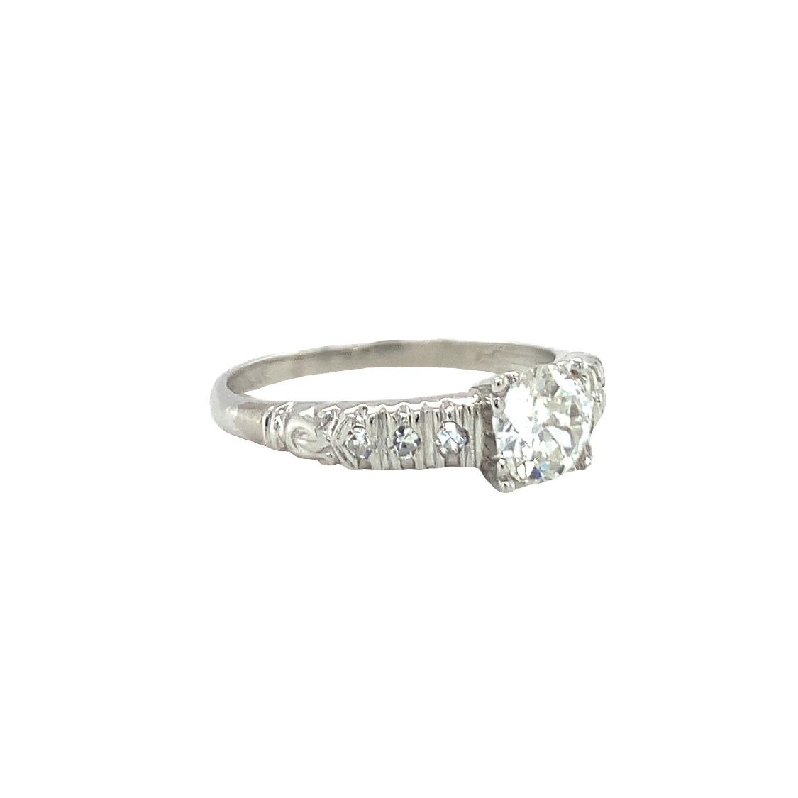 One Art Deco diamond solitaire platinum ring centering one prong set, old European cut diamond weighing 0.60 ct. with I-J color and VS-2 clarity. The center stone is set slightly perched up above while being flanked by six single round cut diamonds
