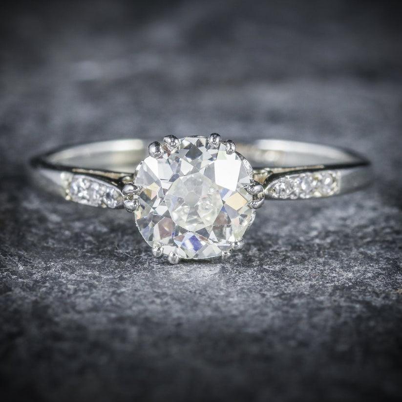 An elegant Art Deco Diamond Solitaire ring claw set with a stunning old European cut Diamond in the centre which is approx. 1.20ct with exceptional VS1 clarity -H Colour. Three smaller Diamonds also chase down each shoulder and total to 0.06ct.