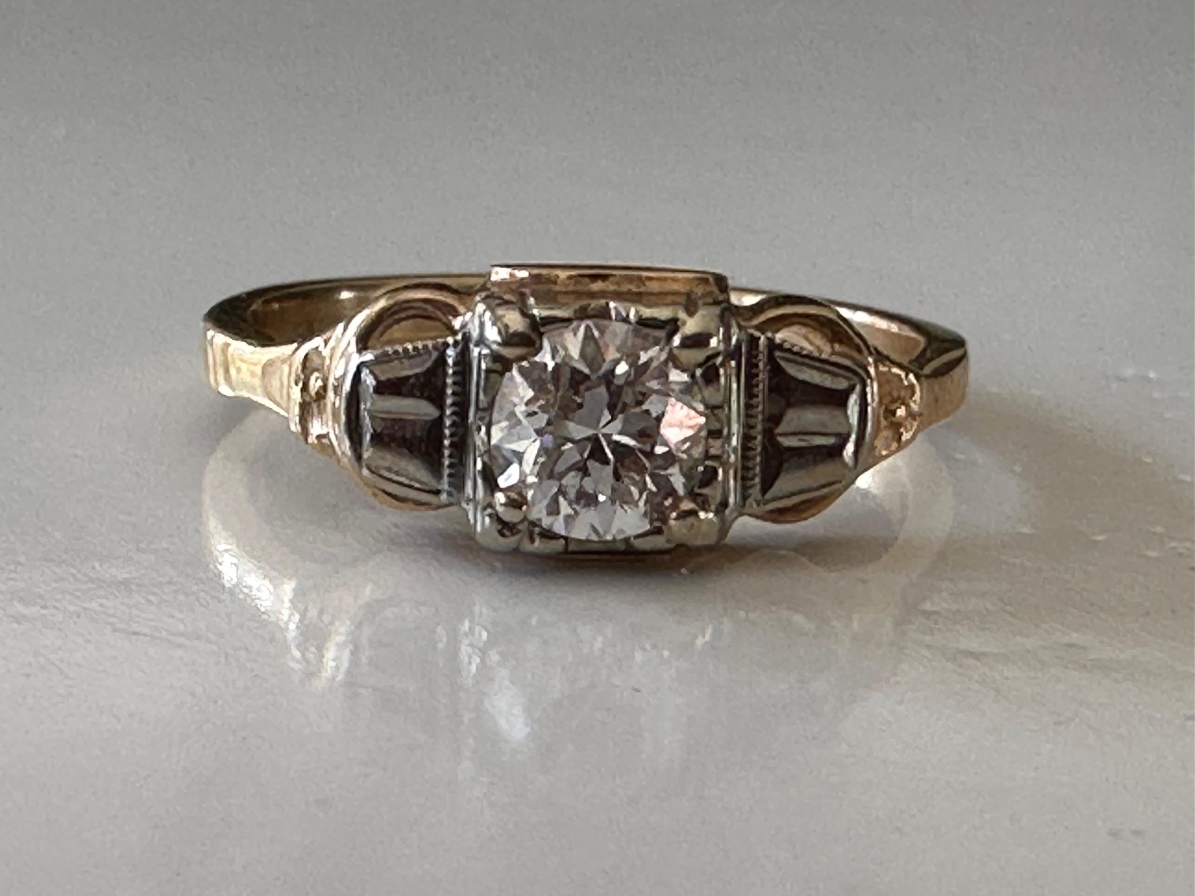 Handcrafted in the 1930s, this Art Deco ring features an Old European cut diamond center stone measuring approximately 0.35 carats, H color, I1 clarity (very beautiful clarity -- the inclusion is not visible to the naked eye). The diamond dazzles