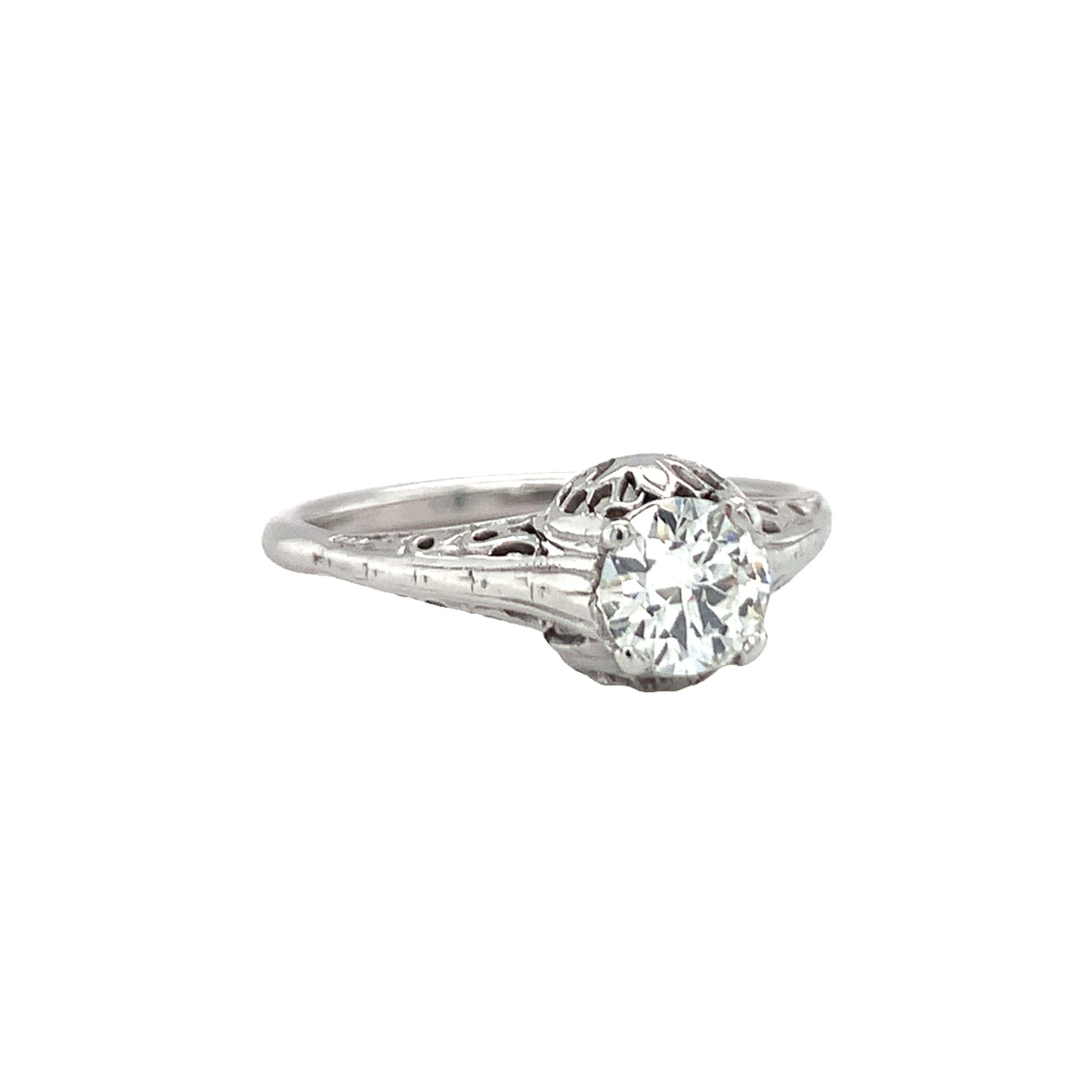 Art Deco diamond solitaire ring handmade in 10K white gold centering one prong set, old European cut diamond weighing 0.70 ct. with I-J color and SI-1 clarity. The ring features open filigree work and engraved details throughout.

Vintage, classic,