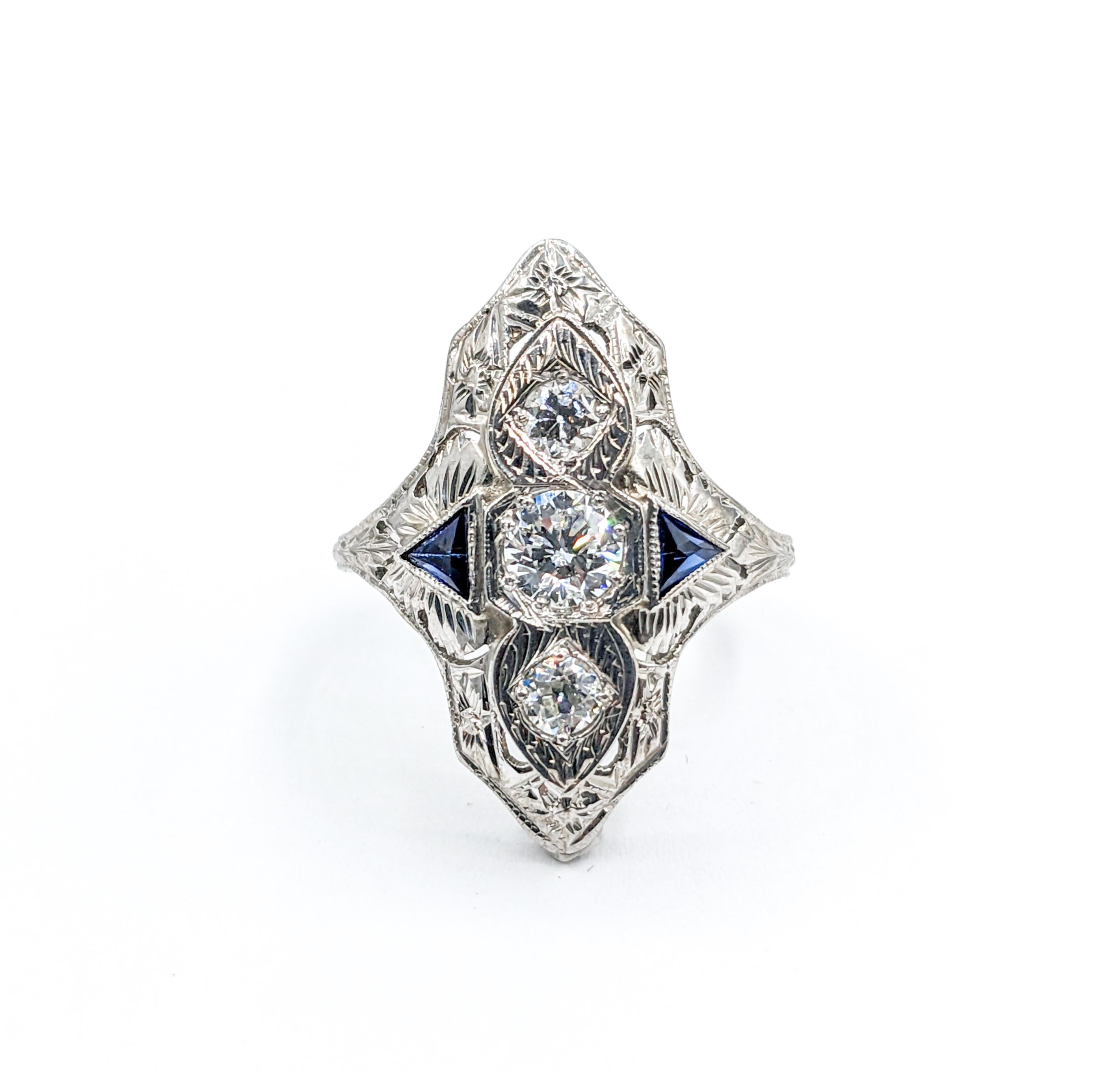 Fabulous Art Deco Diamond & Synthetic Sapphire Ring

Immerse yourself in the age of sophistication with this art deco ring. Precisely crafted in 18k white gold, its design harkens back to an era of unmatched style. At its core, the ring boasts