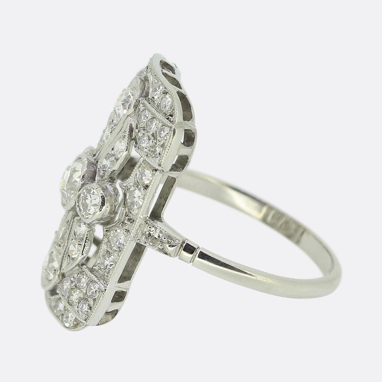 Here we have a stunning diamond tablet ring crafted at a time when the Art Deco style was at the height of design. This ornate platinum piece showcases a rectangular shaped face boasting a multiple layered design consisting of various milgrain