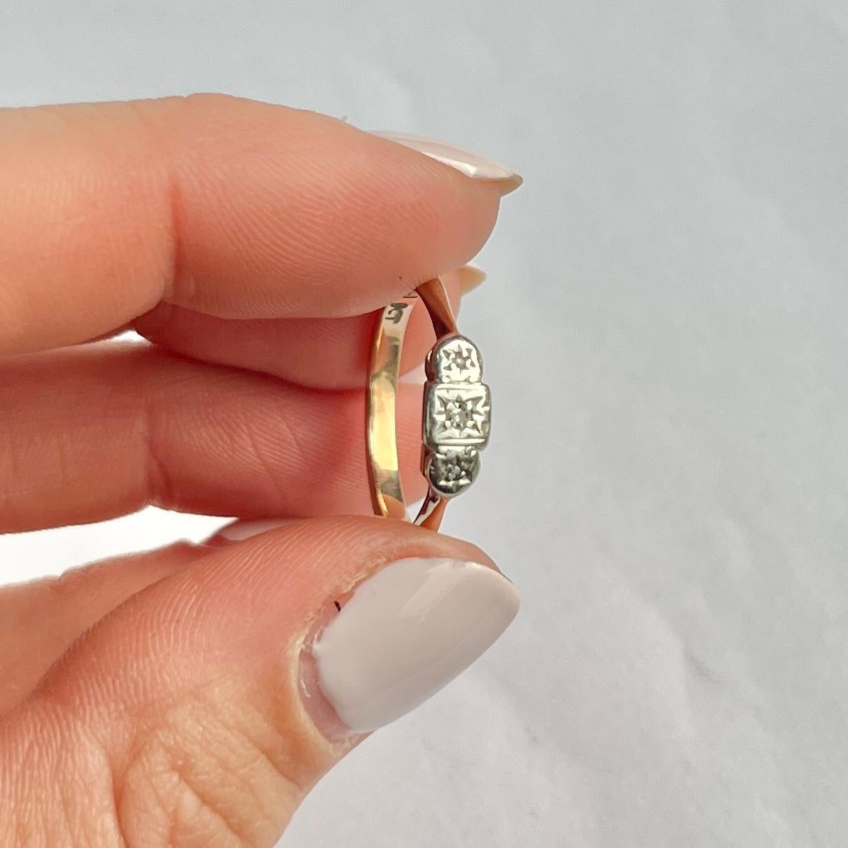Three diamonds sit fabulously on top of a simple setting modelled in 9ct gold and stones set in platinum. The central round diamond measures 3pts and the rose cut diamonds either side measure 1pt each.  

Ring Size: K 1/2 or 5 1/2
Height Off finger: