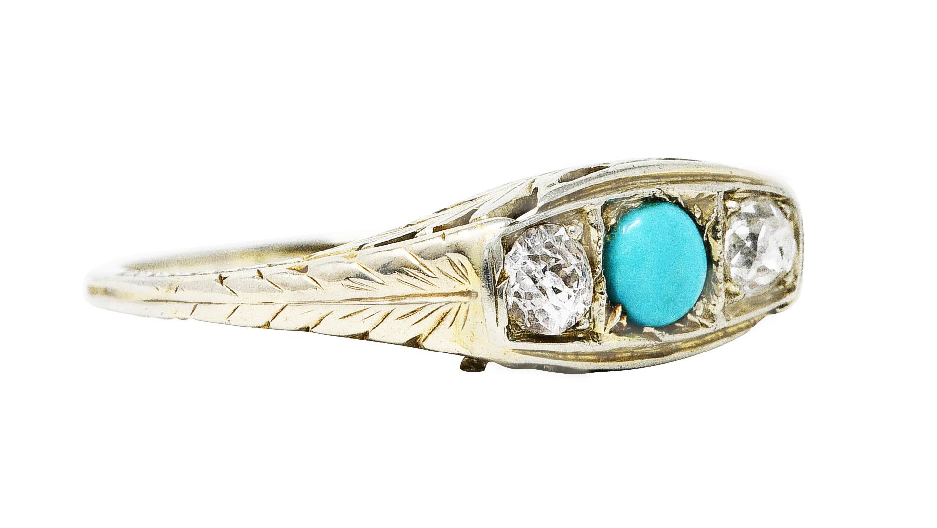 Three stone ring designed with bead setting and engraving

Centering a 4.0 mm round cabochon turquoise - opaque and very saturated robin's egg blue 

Flanked by two old European cut diamonds weighing approximately 0.30 carats in total 

Diamonds are