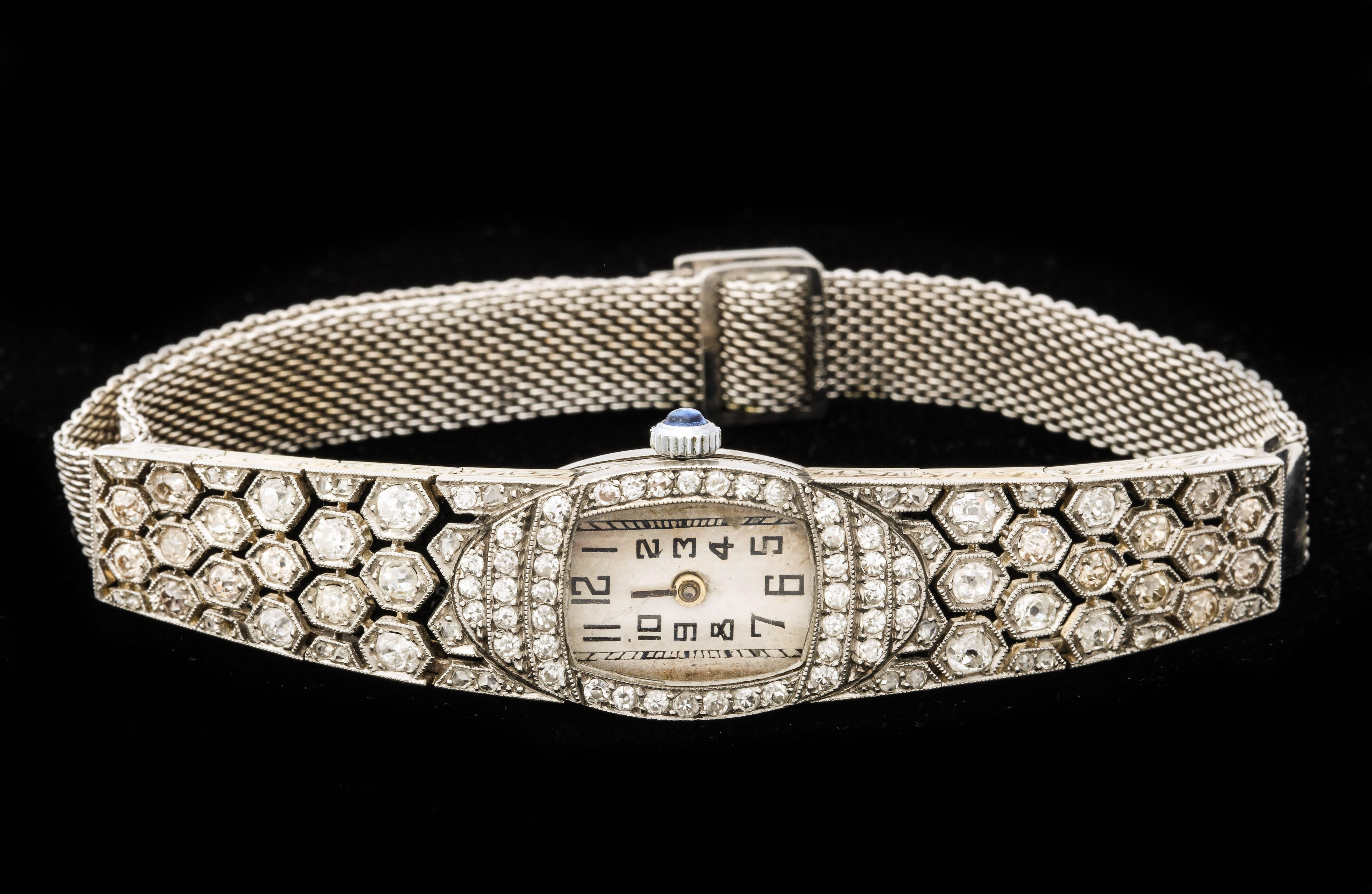 A stunning art deco diamond watch with diamond hexagonal honeycomb link band and swiss movement and sapphire tipped winder